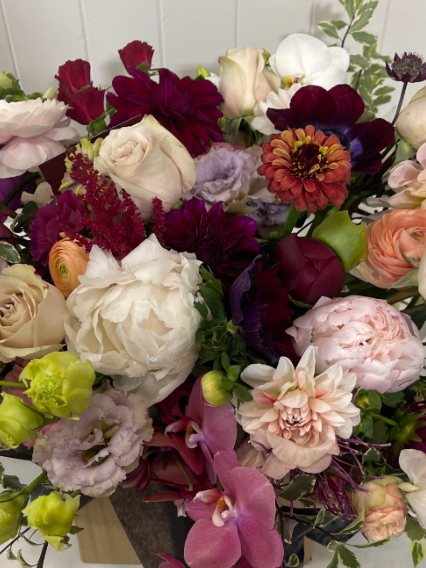 Designer's Choice - Fall Into Autumn - Floral arrangement in seasonal autumn hues - peach, orange, yellow, fuchsia, magenta, burgundy, cream, etc.  Each Designer's Choice vase arrangement will be one of a kind and consist of fresh, seasonal flowers. The arrangement depicted in the photo is just one example of our Designer's Choice - Fall design. Actual arrangement may vary in terms of flower type, color scheme, and overall design depending on seasonal and local availability - but will be similar in size and include flowers of equal value.  Standard - 6"x6" Vase Deluxe - 6.6"x6.6" Vase Premium - 7"x7" Vase