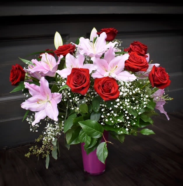 Premium Roses &amp; Lilies - One of our most popular bouquets of all time! This vase has one dozen long stem roses and 6 stems of fragrant pink Oriental lilies accented with foliages and Babies Breath. 