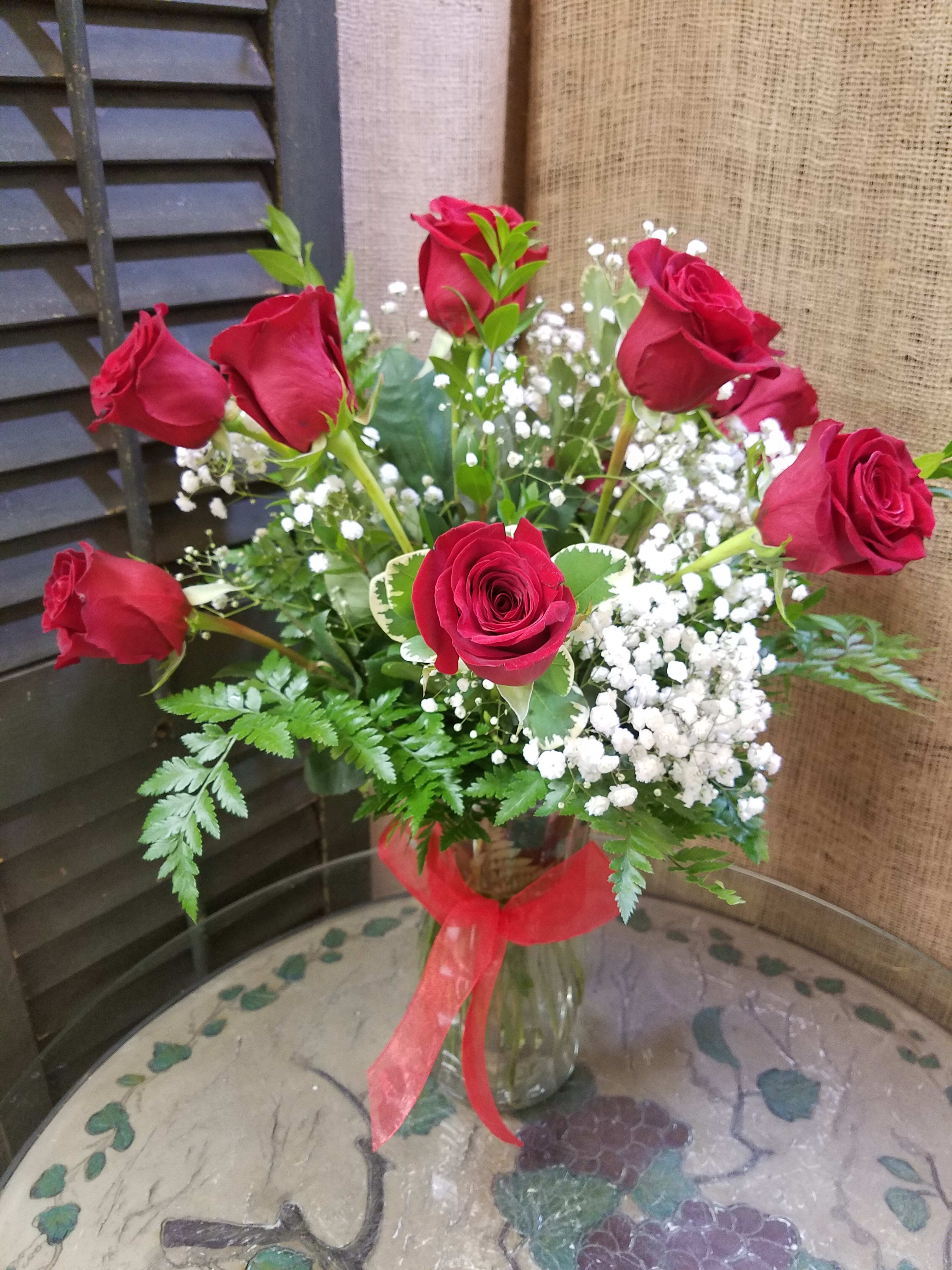 Dozen Red Roses - 1 dozen red roses with babies breath and a bow in a vase.
