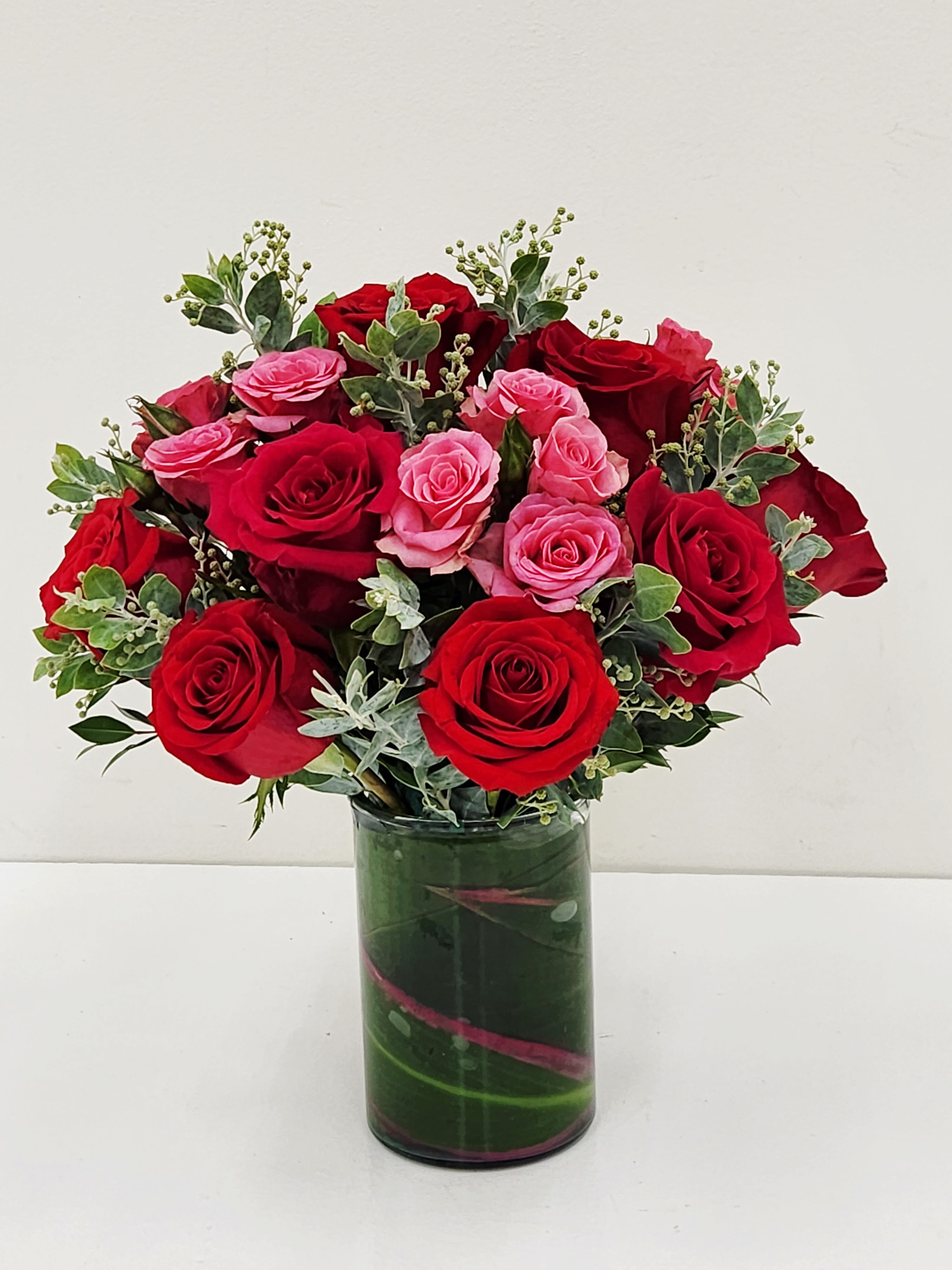 Sweet Love in Long Beach - Celebrate love with Sweet Love in Long Beach.&nbsp; This elegant arrangement of red and pink roses, is artfully blended with lush eucalyptus and accented by exotic ti leaves that line the vase. A sophisticated expression of romance and affection, this bouquet captures the essence of devotion in every petal. Perfect for anniversaries, Valentine's Day, or any moment worth cherishing.