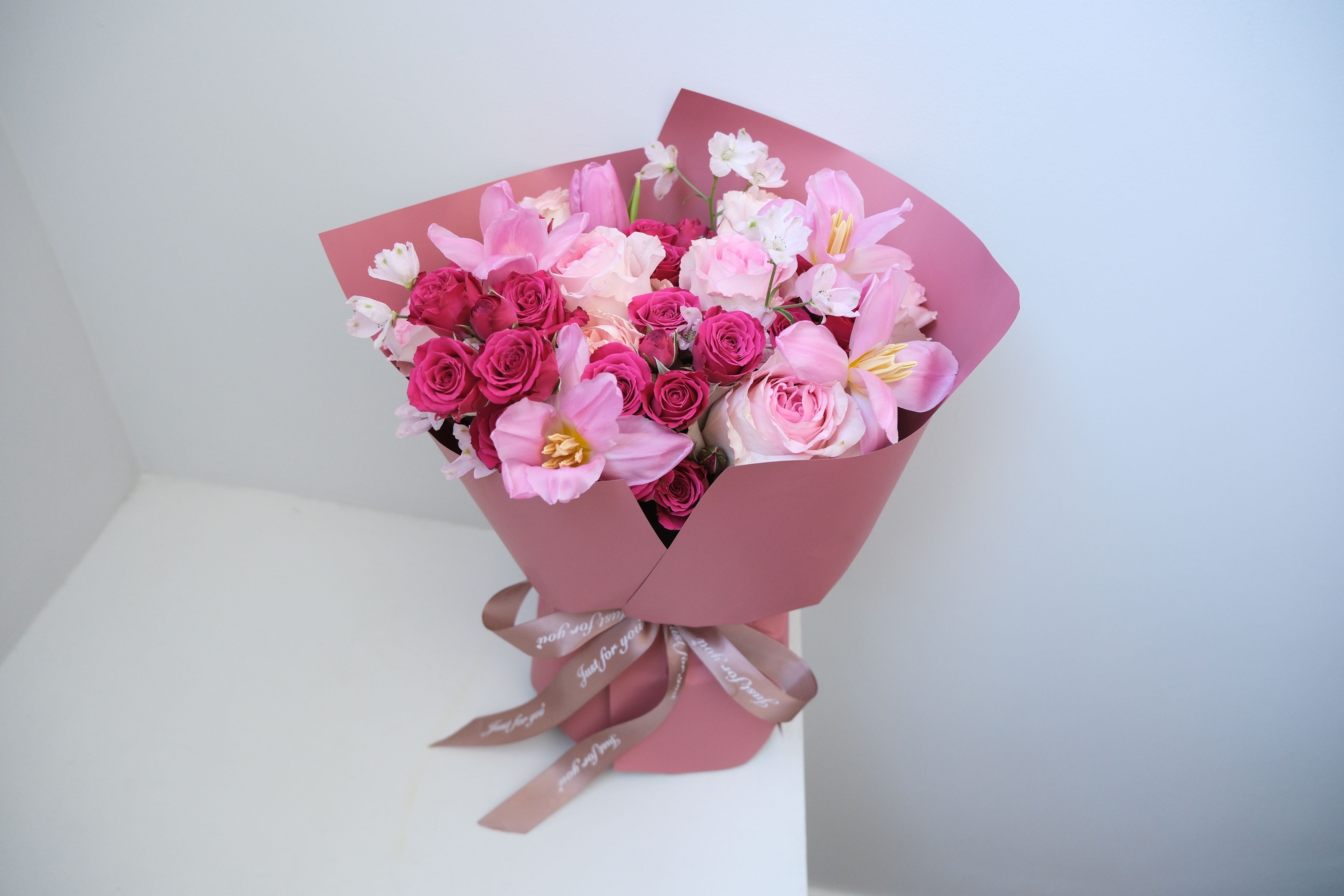 Pink Embrace Tulip and Roses - Tulips for tenderness, roses for romance — wrapped together in a bouquet that feels warm, pretty, and full of charm.