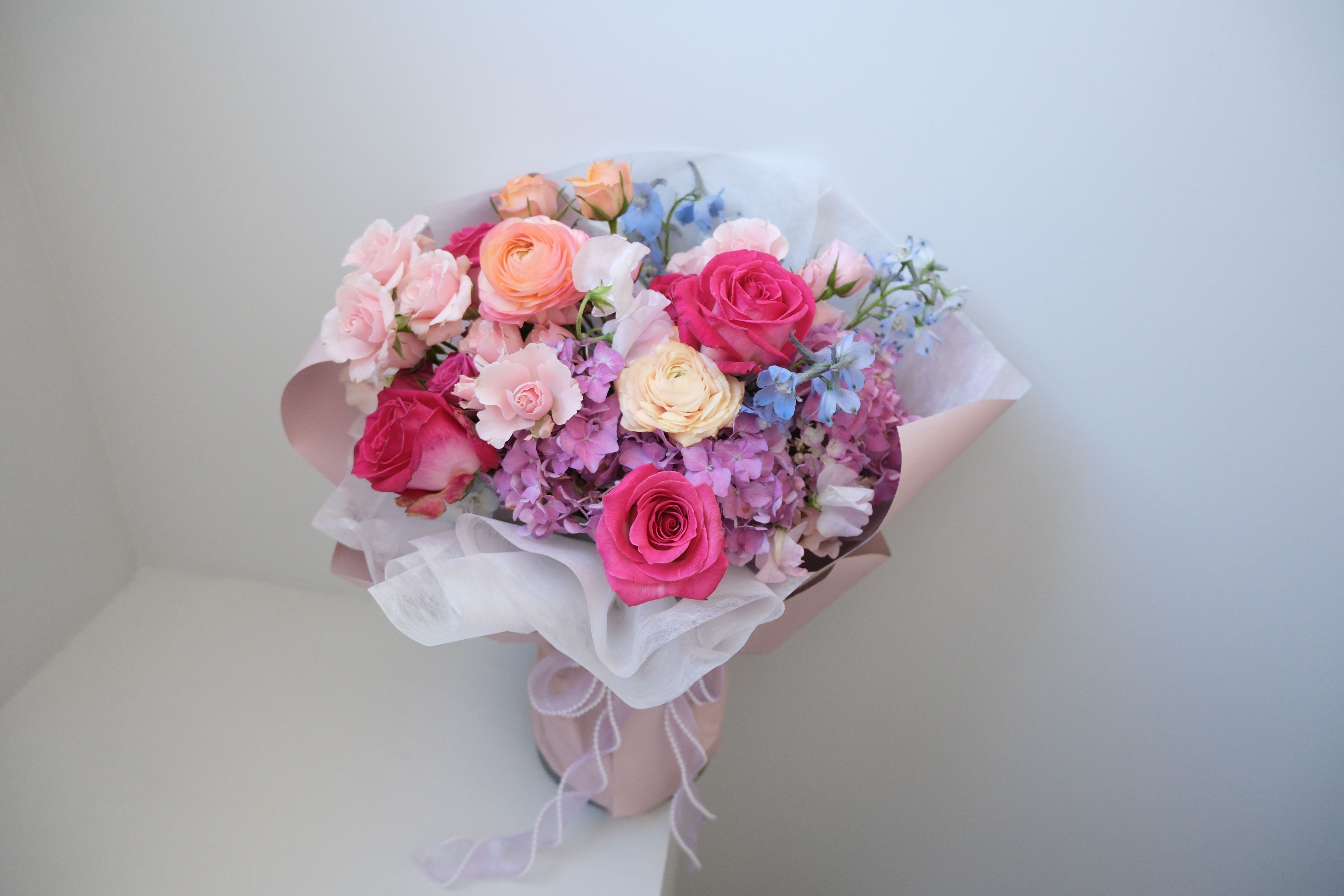 Fresh, Colorful &amp; Cheerful Roses Bouquet  - A colorful pastel blend of premium ranunculus and roses, arranged with soft layers and clean wrapping. Fresh, stylish, and beautifully uplifting. Perfect for celebrating life’s sweetest moments!