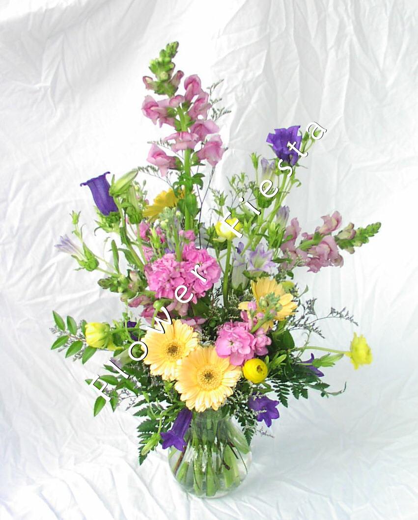  Pastel mixed spring flowers - Soft colors and a variety of spring flowers to lighten up this Mother's Day.  A carefree happy combination including greens and filler flowers in a small clear glass vase. Designer's choice of seasonal flowers.  Classic Mother's day bouquet