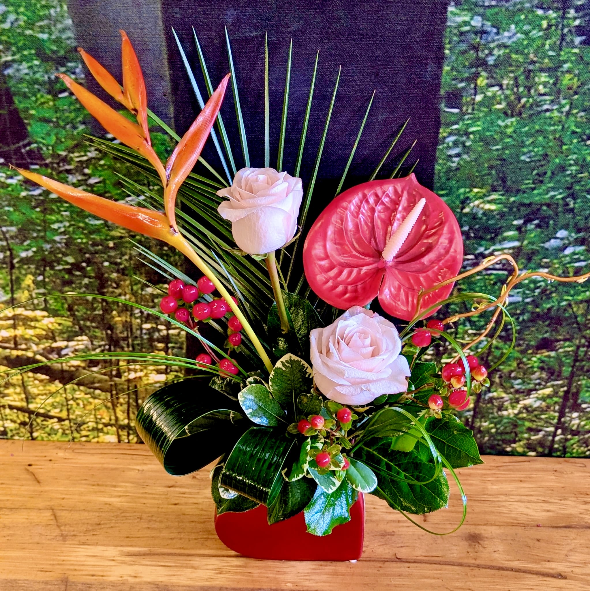 Unique Love - For the love that is one of a kind- A beautiful &amp; unique flower design. Includes an assortment of tropical and garden flowers in a unique heart shaped vase. Includes Heliconia, Roses, Berries, accents of tropical foliage, and a faux red red keepsake Anthurium. 