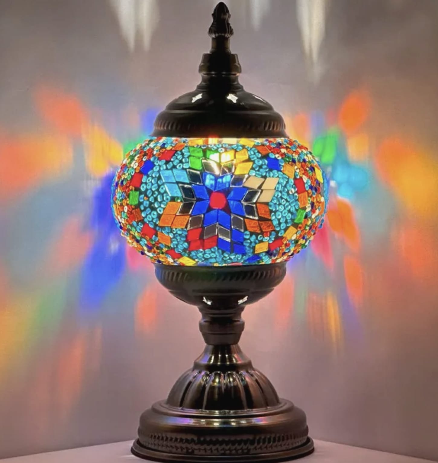 Round Mosaic Lamp - These beautifully crafted lamps are made with colourful glass pieces in intricate designs that create a warm and inviting atmosphere in any room. Good for sympathy gifts or just a gift to brighten someone's room! Please note: Photos are for reference only. Actual designs and quotes may vary. If you are looking for a specific style we kindly ask that you give us a call to discuss availability and options.