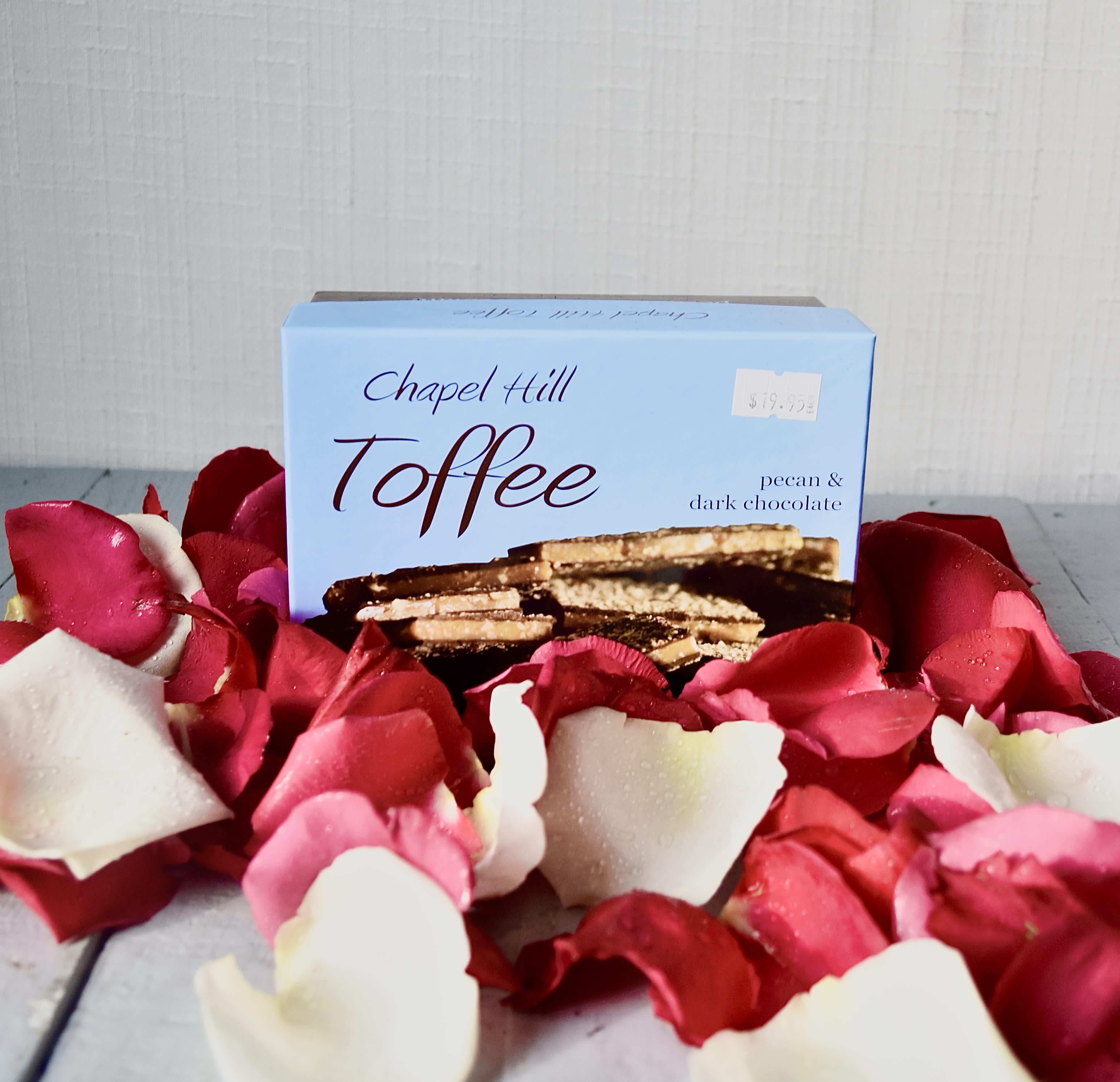 Chapel Hill Toffee (10 Ounces) - Make a statement and send a box of pecan and dark chocolate with your arrangement!  Made local in Chapel Hill. Gluten Free. Chapel Hill Toffee (10 Ounces) READ: This is an add-on product and can only be purchased alongside a flower arrangement or plant. Do not purchase by itself- you will not be refunded!