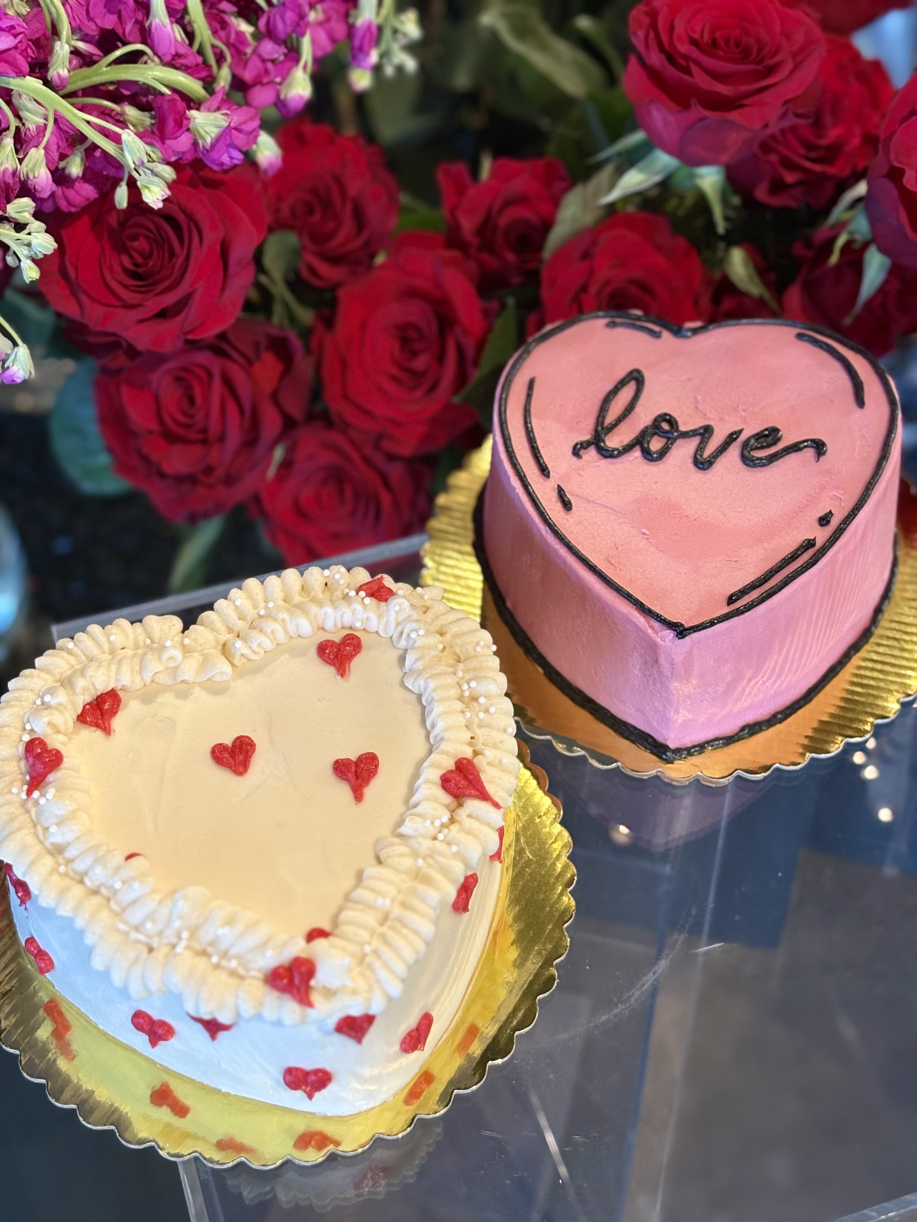 Valentine's House Made Cakes - Delicious is an understatement! Our beautifully decorated and perfectly balanced house made cakes are available in two flavors.  Our "White Cake" Vanilla cake with fresh strawberry filling and cream cheese frosting. Our "Pink Cake" Red velvet with cream cheese frosting.  Please specify your flavor choice under "Special Instructions"