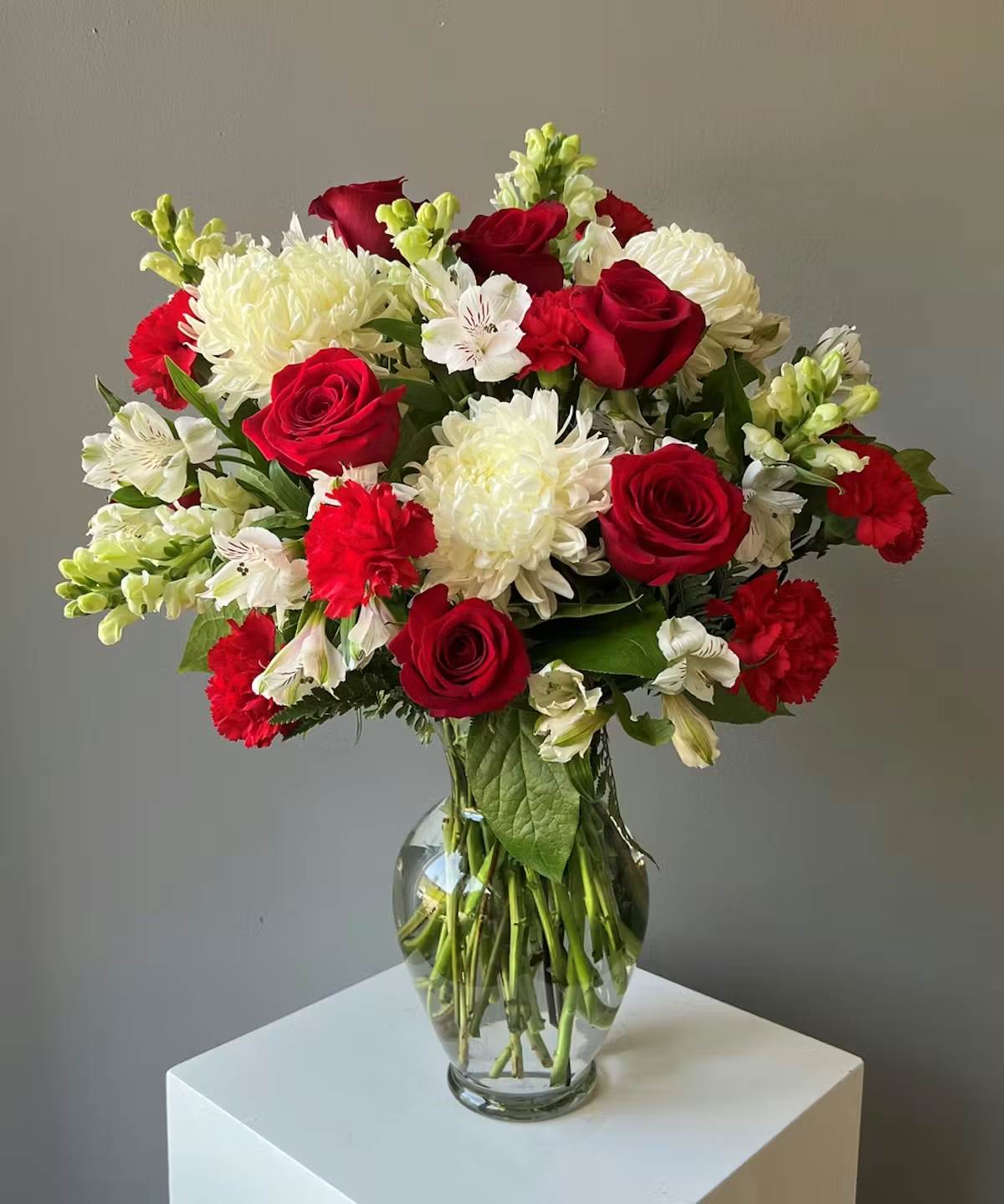 True Love Bouquet - This Valentine's Day, declare your deepest feelings with the "True Love" bouquet, a stunning arrangement that captures the essence of enduring passion and pure devotion. This exquisite mix of classic red and pristine white blooms is a timeless symbol of a love that is both fervent and true.