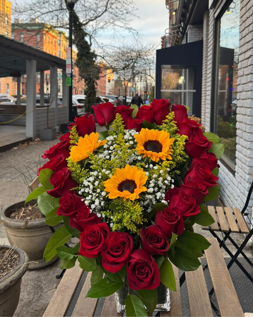 Golden Love. - Golden Love is a celebration of love and light in one arrangement. Designed in the shape of a heart with red roses, a symbol of passion and eternal love, this arrangement is enriched with golden sunflowers in the center, which add warmth and joy.