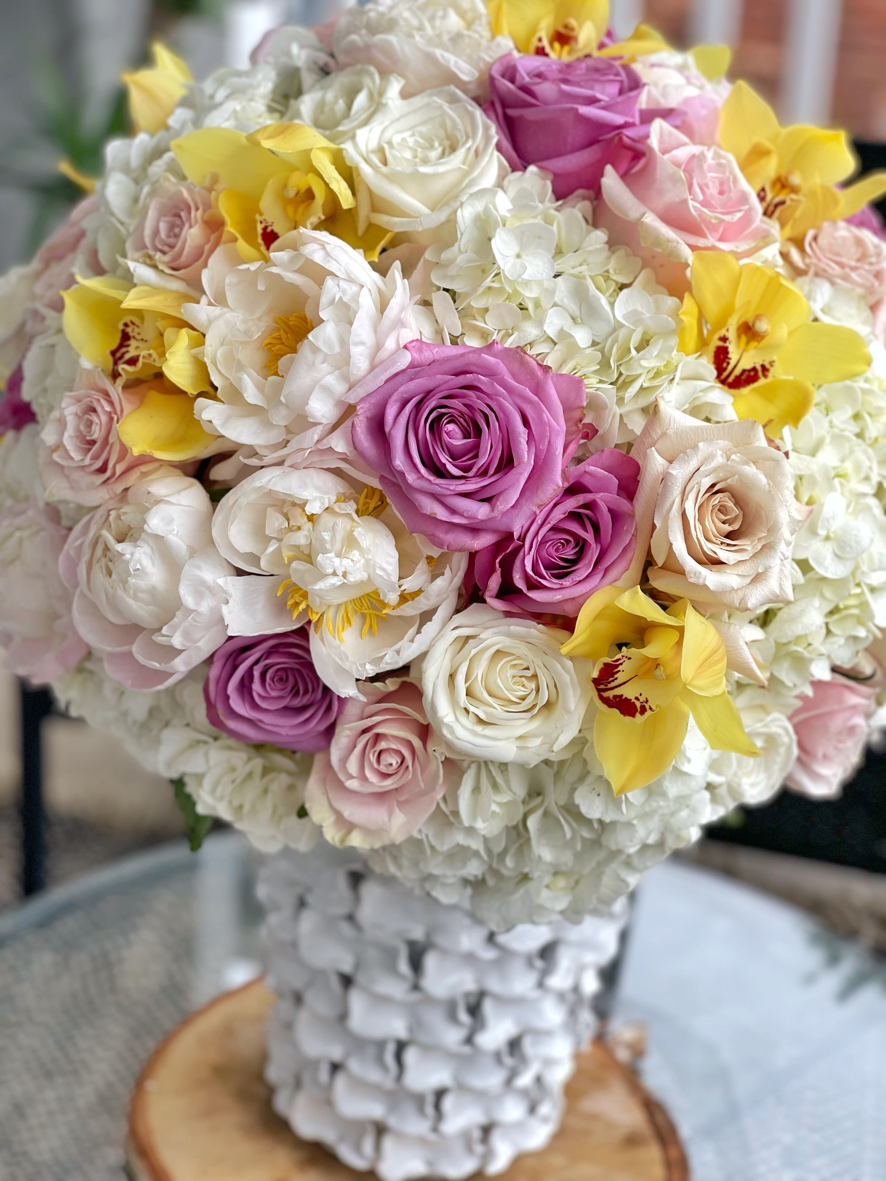 Fifth Avenue - Fifth Avenue is the ultimate arrangement for MOM.  - Delicately arranged by our professional florists with Peonies, Hydrangeas, Roses, and Cymbidium Orchids. - Arranged in a 7.75'' x 13'' Mandy Vase. - Careful selection of the freshest flowers available (Shade may vary due to availability). - To guarantee the longevity of the flowers, some may arrive in bud or close form and will fully bloom over the next few days.