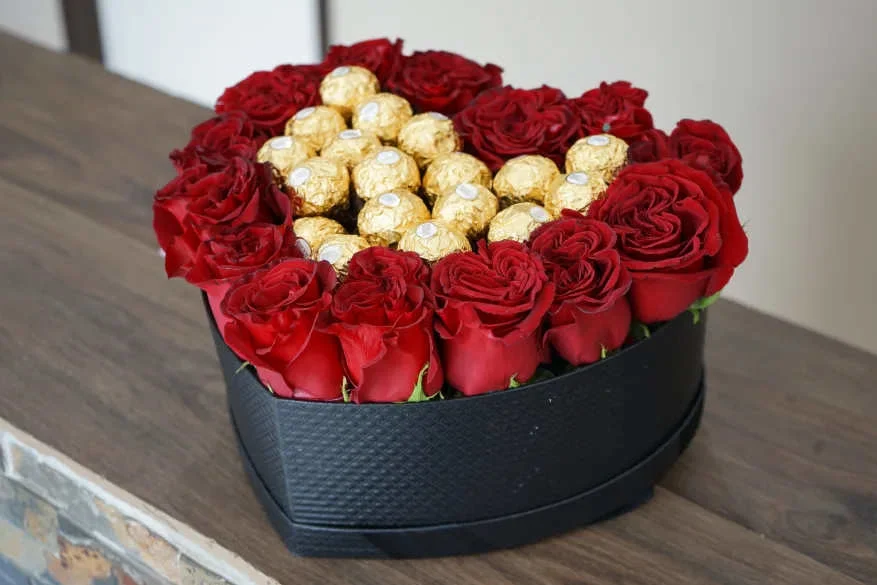Roses and Chocolates - Win her heart with roses and chocolates in a heart shaped box. Standard size contains 14-16 roses and 18 Ferrero Rocher chocolates. Rose color can be changed to what customers wish.