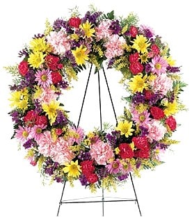 Classic Sympathy Flowers Wreath - A symbol of hope and lasting love, this popular classic sympathy wreath features hearty seasonal fresh flowers in a rich tapestry of Spring colors. Classic Sympathy Wreath features Chrysanthemums, Carnations, Daisies, Alstroemerias and other seasonal favorites. Appropriate for wakes, funerals, and memorial services. Displayed on 60in tall easel stand.  Standard - 18in Wreath - Overall Size (With Flowers) 22in (H) x 22in (W) - 60in Tall Easel Stand Deluxe - 22in Wreath - Overall Size (With Flowers) 26in (H) x 26in (W) - 60in Tall Easel Stand Premium - 24in Wreath - Overall Size (With Flowers) 28in (H) x 28in (W) - 60in Tall Easel Stand  Please Note: This is a special order floral arrangement. Place your order online and allow at least 1-2 business days for order processing. Please give us a call at 619-237-8842 for same day delivery options.