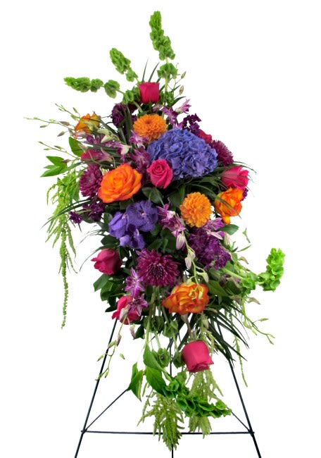 Precious Gems Sympathy Spray - Celebrate life with this Sympathy Spray in rich jewel tones. Featured flowers include premium Roses, Dutch Hydrangeas, Dahlias, Vanda Orchids, Dendrobium Orchids, Stocks, Bells of Ireland, Amaranthus or similar seasonal favorites. Life is precious, and so are those special people we have loved and lost.  Our vibrant Precious Gems Sympathy Spray is appropriate for wakes, funerals, and memorial services. The flowers measure approximately 25in (W) x 50in (H), for a total of approximately 80 inches (H) when displayed on the easel stand. Deluxe and Premium styles are larger and feature more premium blooms.  Please Note: This is a special order floral arrangement. Place your order online and allow at least 1-2 business days for order processing. Please give us a call at 619-237-8842 for same day delivery options. Some substitutions may be necessary due to seasonal availability of certain blooms used in this composition. We can assure you that your order will only be upgraded with same or higher value premium blooms if a substitution is unavoidable.
