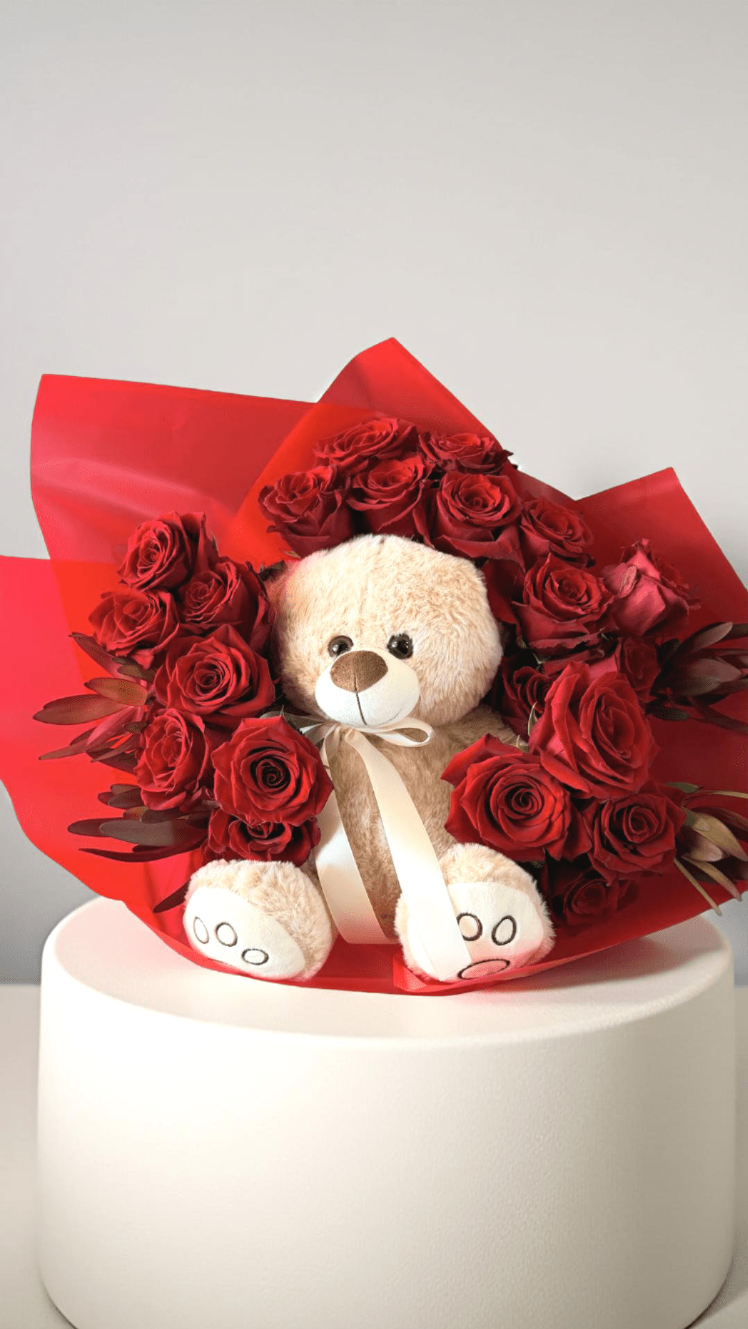 Love and Cuddles - A charming bouquet of classic red roses paired with an adorable plush teddy bear, offering a perfect blend of romance and comfort for your special someone.