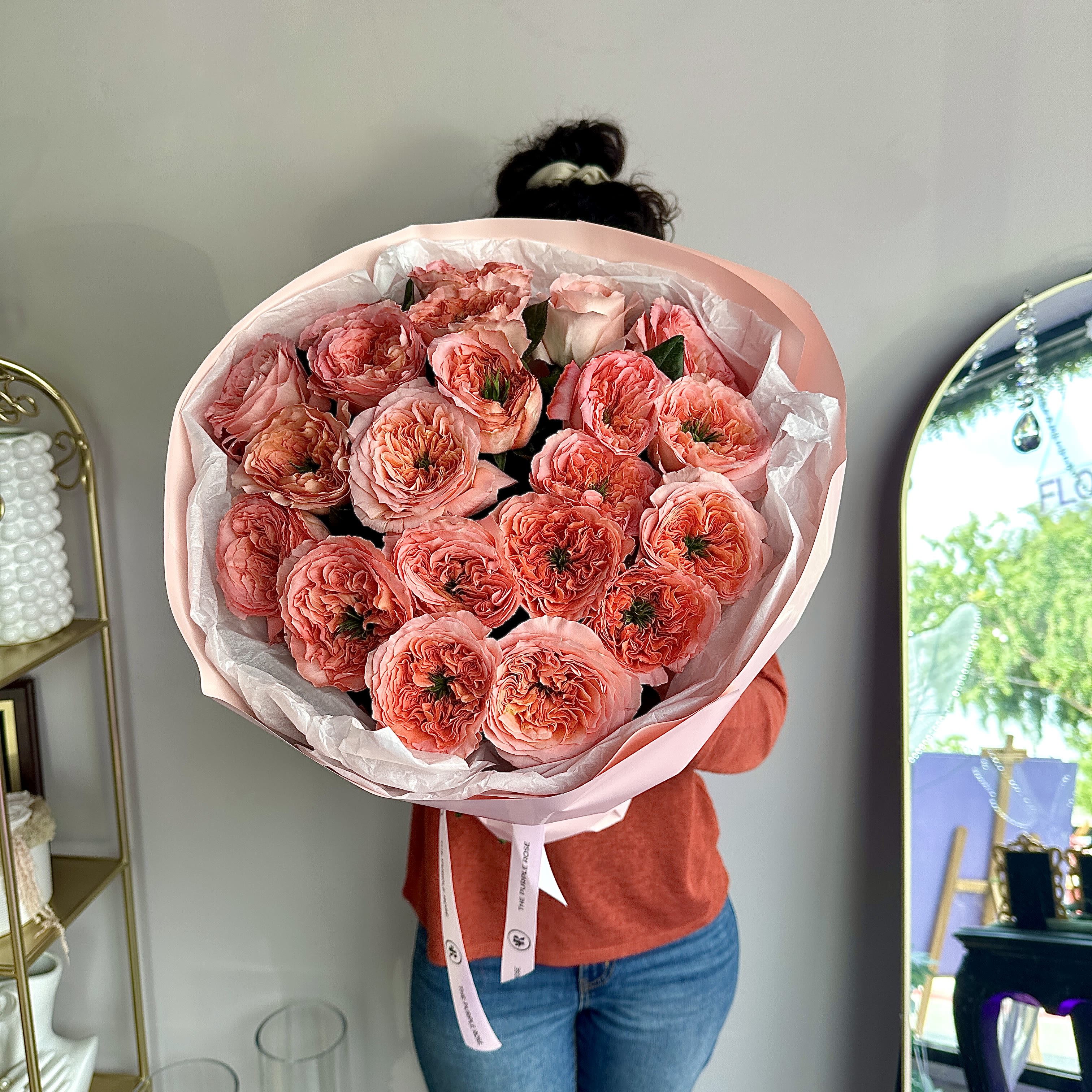 112D- Garden roses in bouquet (12/24/50) - Full of charm and texture, this bouquet of coral-toned garden roses is a statement of elegance. With layered petals and rich color, it’s the perfect blend of beauty and sophistication—made to impress. DELUXE size is shown in the picture.