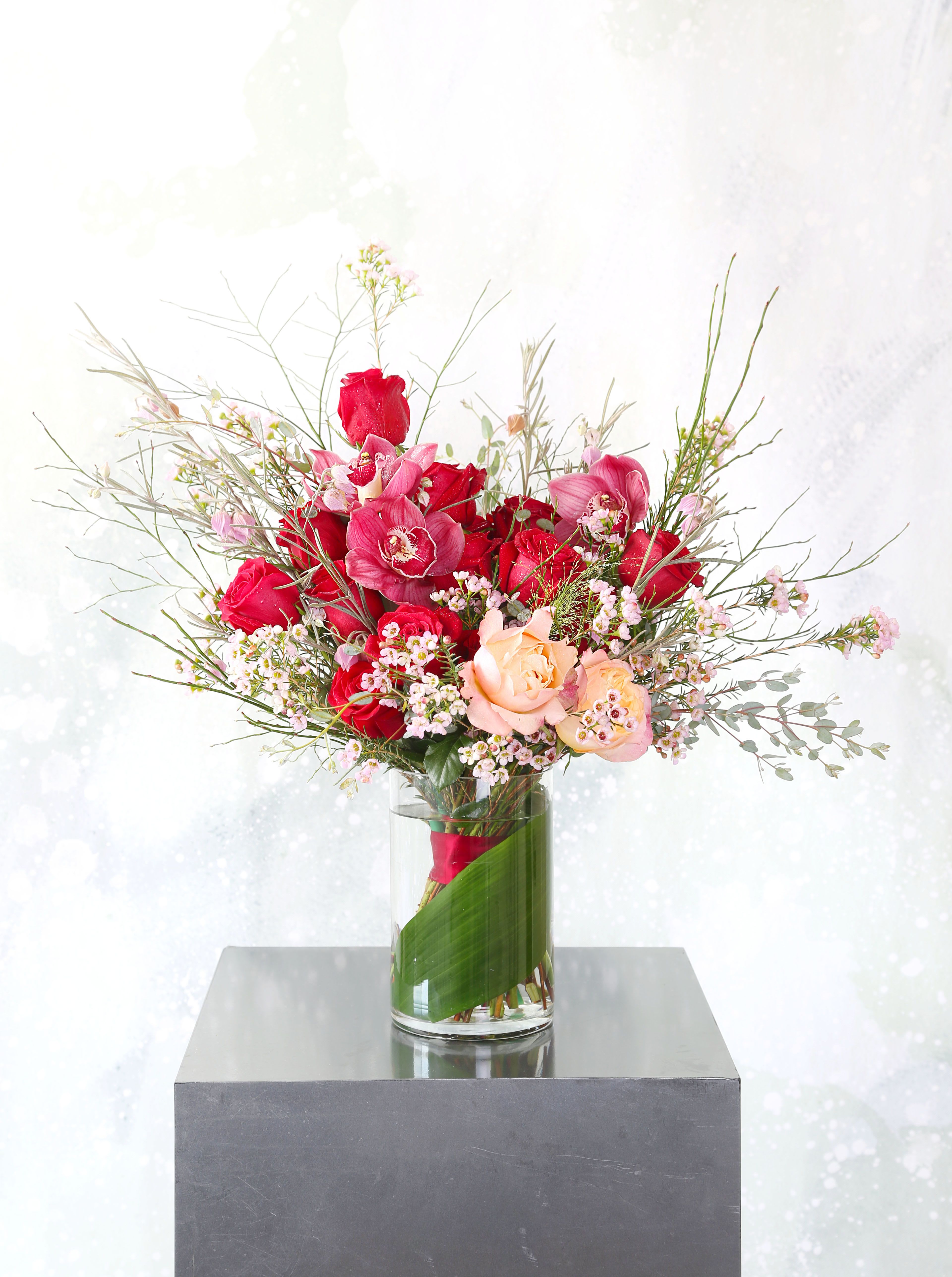 Love - A modern touch of a traditional One &amp; a half dozen red rose arrangement creates on the Red Garden rose in seasonal green and mix bloom with 2 Juliet Graden rose and Cymbidium Orchid as accent to add a uniqueness. This arrangement is created for a 6" tall cylinder, it is perfect for the one you love and whoever easy for eyes with lots of textures, lines and variety of depth, It will be delivered with branded gift box and greeting card