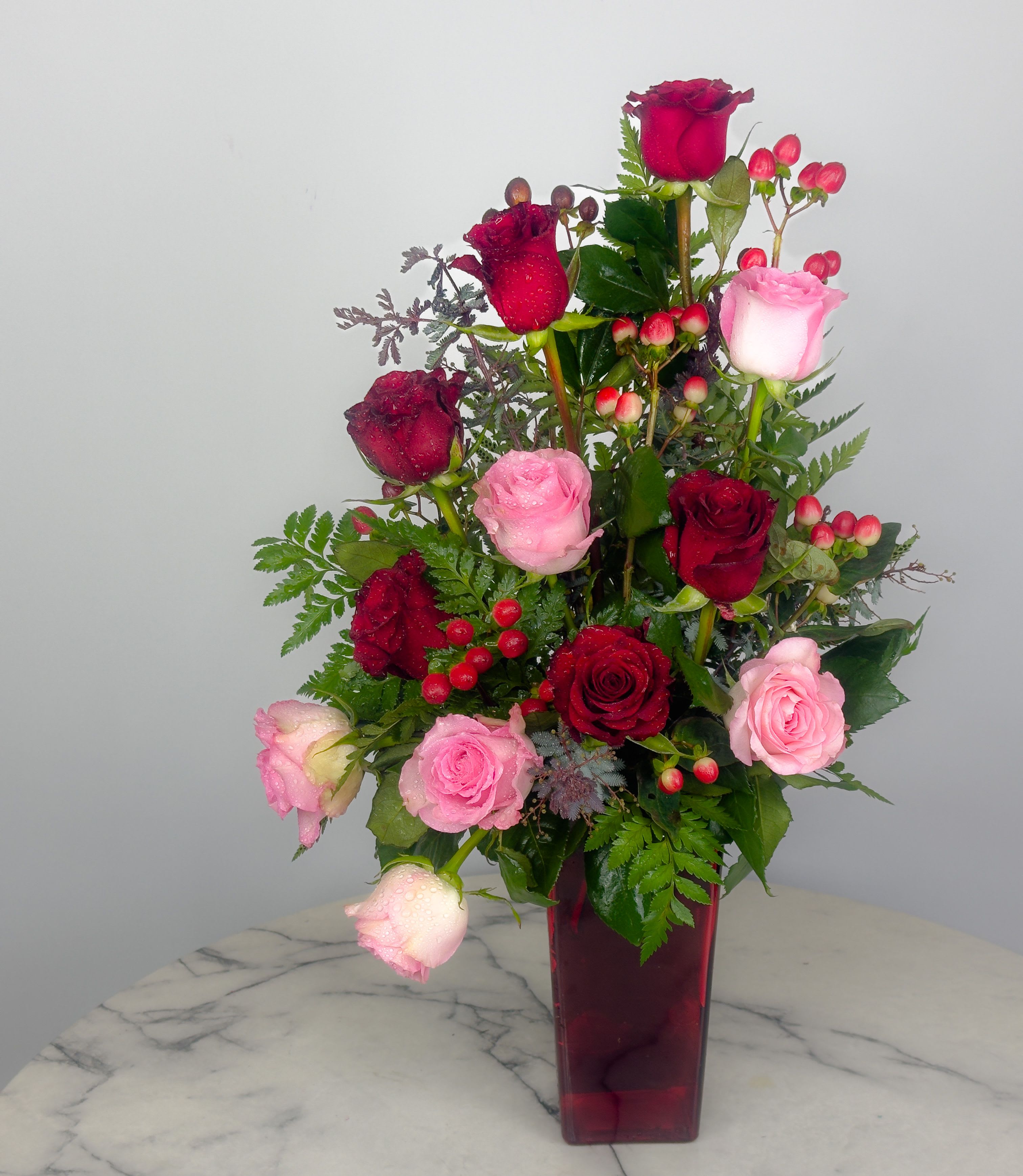 Contemporary Dozen Roses - A dozen roses elegantly designed with a contemporary flare! Great for birthdays, anniversary, get well, to say thank you, to express you love on Valentine's Day, greet your mom on Mother's Day or just because.  We have all color roses available! For your preferred other than what is shown, please indicate under “Special Instructions” before checkout.  Approximately 18" H x 10" W  