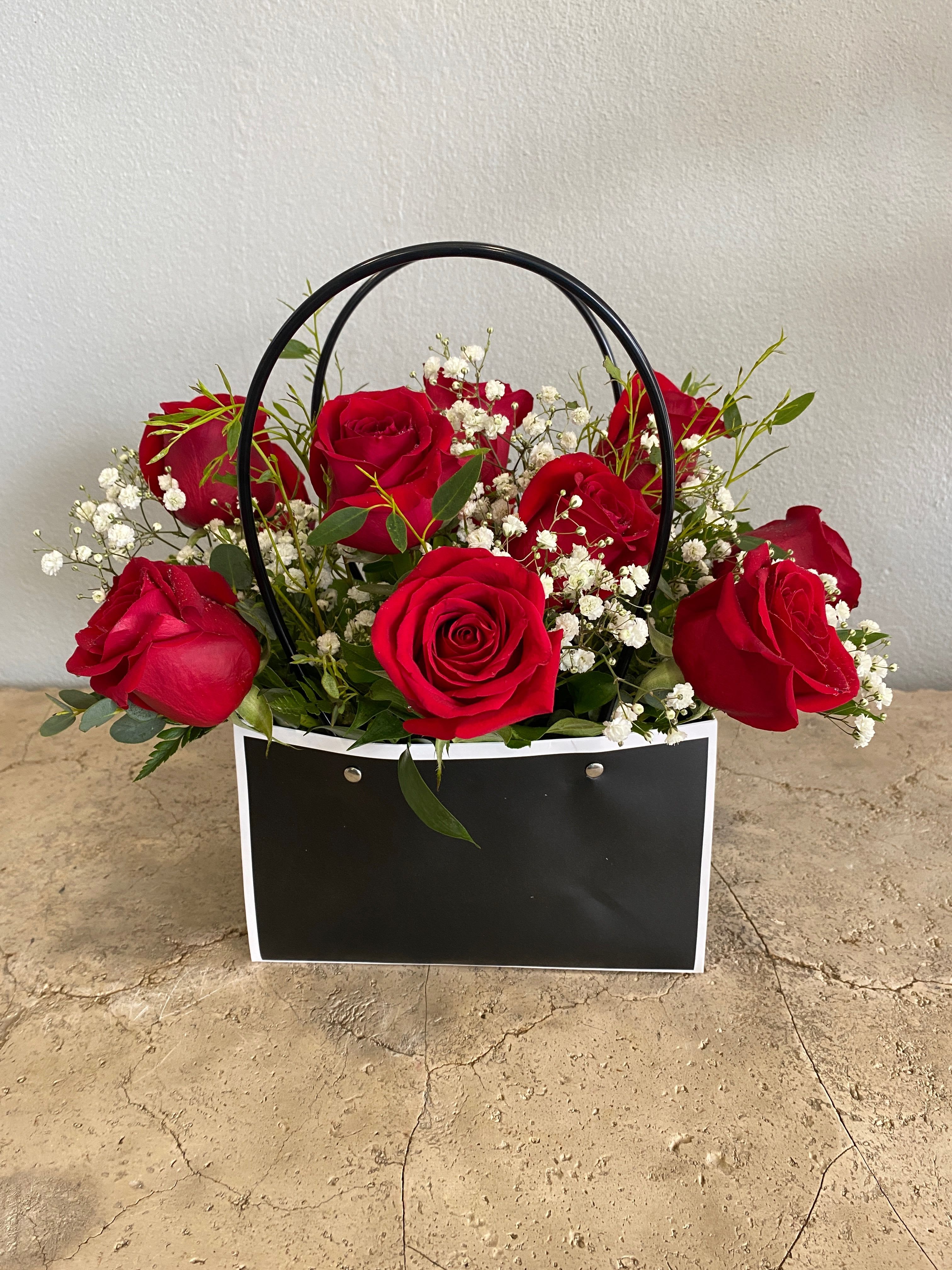 Bag of Love - One dozen premium Red Roses are artfully crafted in a waterproof rectangle bag with greenery and filler flowers by our talented florists. available for pickup or delivery in our listed delivery areas.