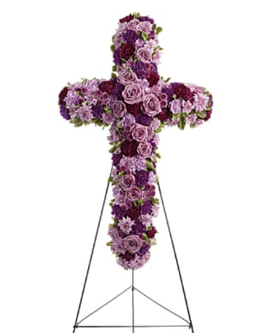 Deepest Faith - This elegant cross spray is beautifully designed with an assortment of flowers, including graceful roses and classic carnations, in soft light purple and rich dark purple tones. The flowing blend of lavender and deep violet hues symbolizes dignity, admiration, and remembrance, while the floral cross shape adds a meaningful expression of faith and devotion. Thoughtfully arranged with gentle greenery, this spray serves as a heartfelt tribute honoring a cherished life with grace and reverence.  