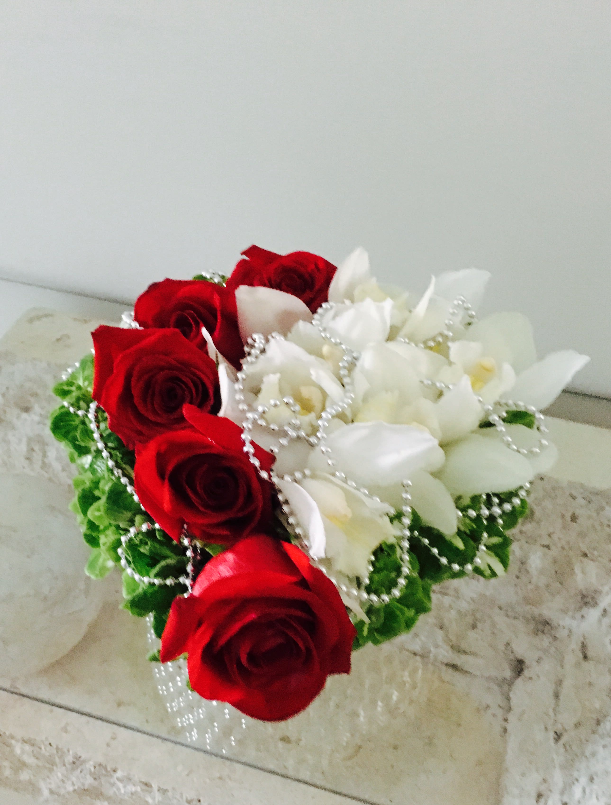 Gift of Love - An expression of love for Someone dear and special . Red roses, white orchids with decorative pearls. In a heart shaped container.  Available for next day delivery or in store pickup in West Palm Beach, Palm Beach, Palm Beach Gardens, and surrounding areas. 