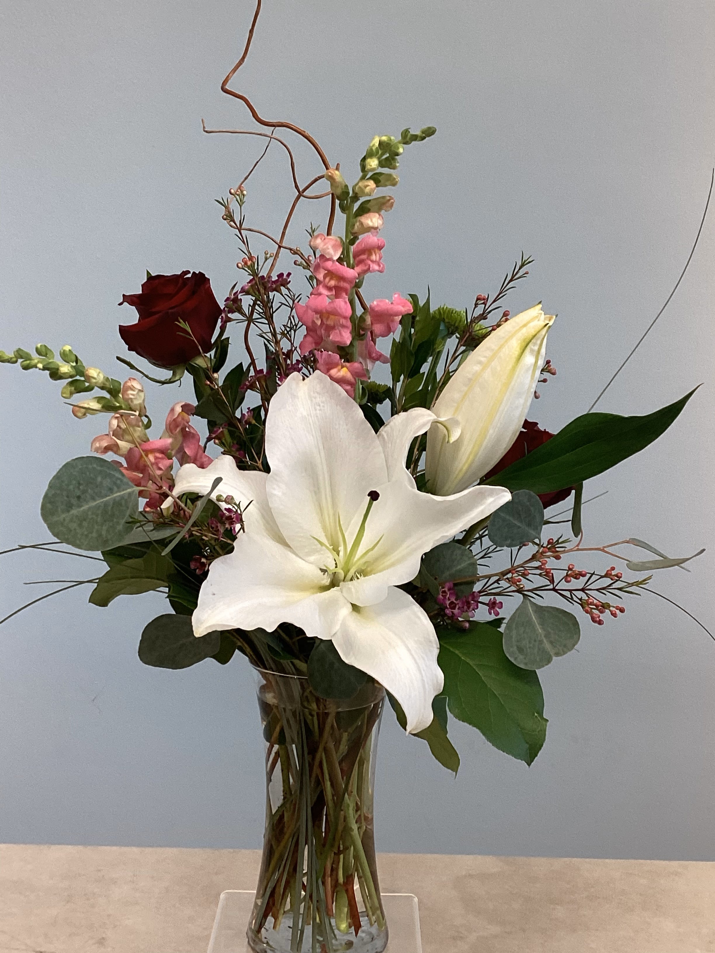 V-2 - Beautifully paired snap dragons, roses, and lilies with other coordinating flowers. 