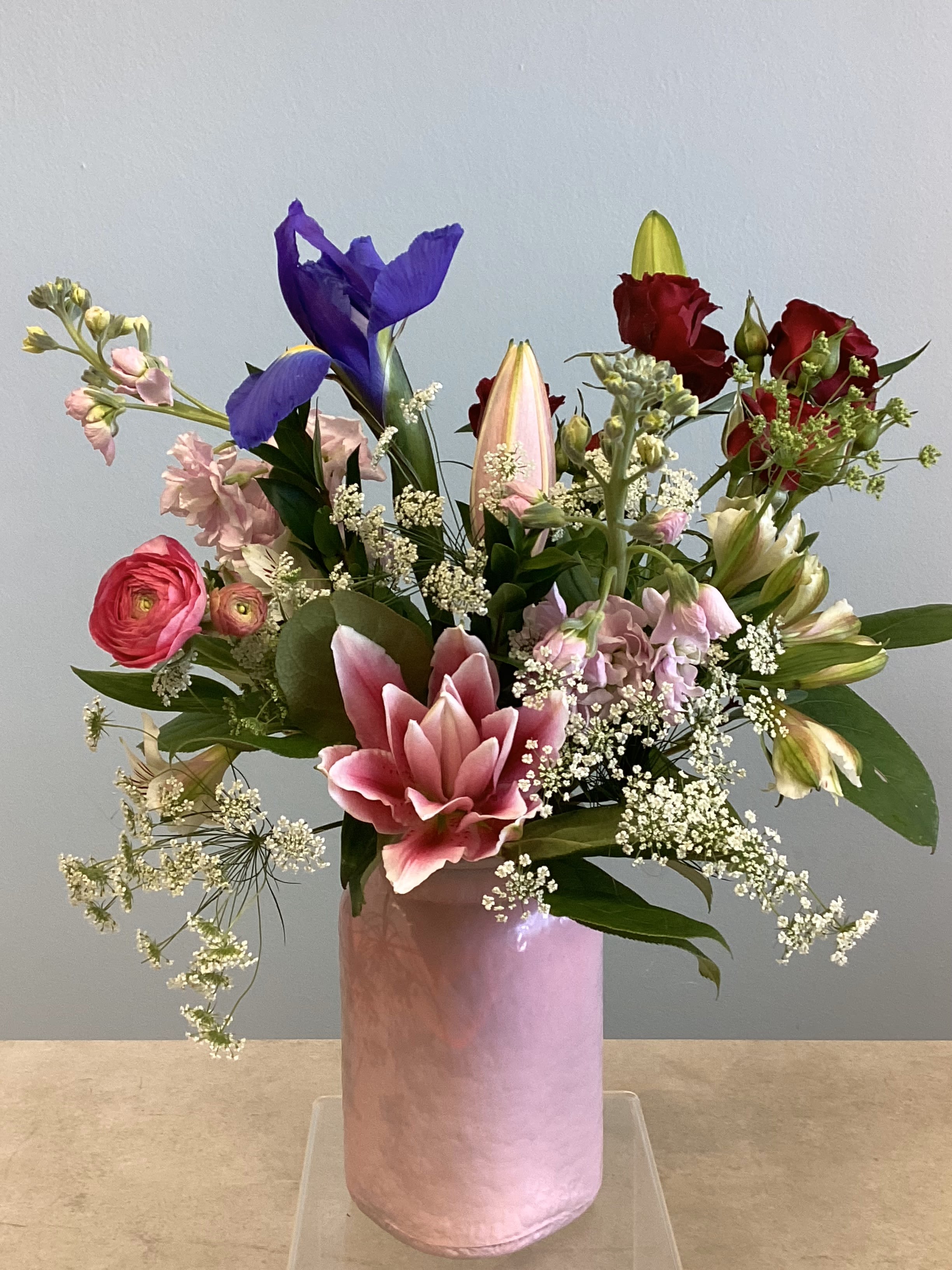 V-3 - A delightful spring mix featuring lilies, roses, and ranunculus with other coordinating spring flowers. 