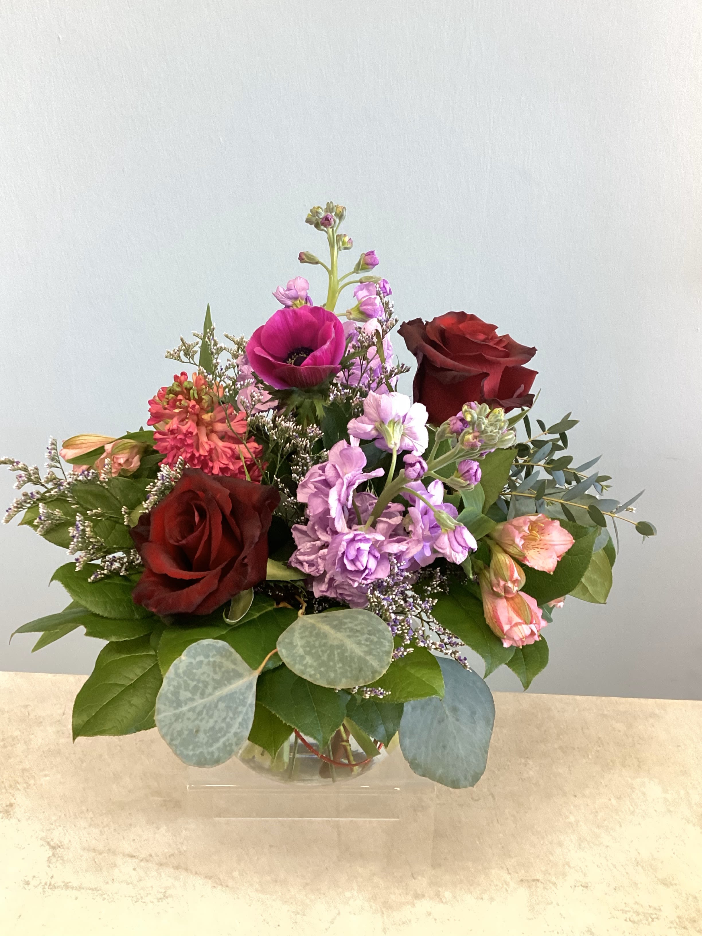V-6 - A low-profile arrangement of roses, stock, anemones, and other coordinating Spring flowers. 