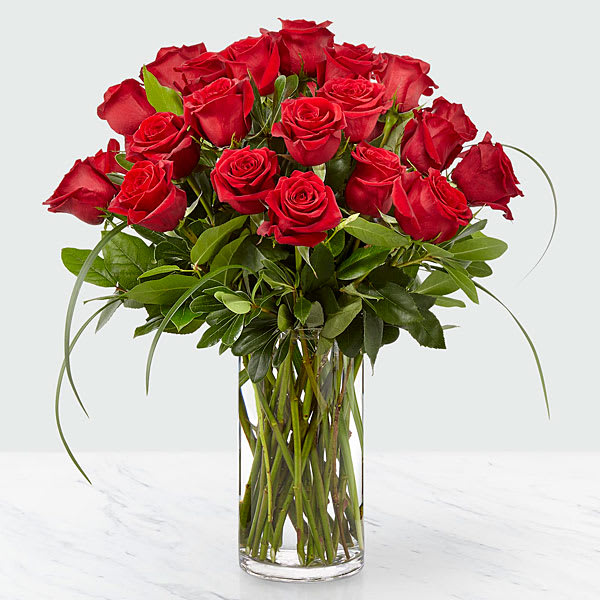 Everlasting Love Rose Bouquet - A heartfelt collection of red blooms sits among an array of assorted green placed in a simply modern glass cylindrical vase perfect to deliver a special message. 