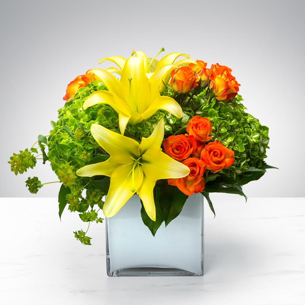 Cube of Wonder by BloomNation™ - Do you find yourself wondering what’s in this Cube of Wonder? Wonder no longer, you’ve come to the right place. Featuring a vibrant array of lilies, spray roses, and hydrangea, this wonderful arrangement is the perfect gift to celebrate a birthday or new beginnings.  Additional color varieties available. Our florists hand-design each arrangement, so colors, varieties and container may vary due to local availability. Same day delivery may not be available due to time constraints.