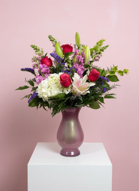 Cutie Pie  - Cutie Pie is a romantic Valentine’s Day arrangement designed to express love in the sweetest way. Lush roses set the tone for romance, while fragrant Sorbonne lilies add elegance and passion. Full hydrangea create a soft, luxurious backdrop, and touches of purple statice bring depth and a hint of whimsy. Rich in texture and heartfelt beauty, Cutie Pie is a charming way to say “be mine” and celebrate love on Valentine’s Day. 
