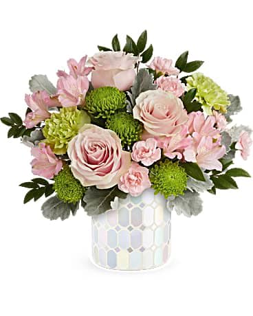Teleflora's Pretty Pop Bouquet - Embrace timeless elegance with our iridescent mosaic glass cylinder, radiating soft pastel shimmer that beautifully complements an overflowing bouquet of pink flowers, adding a touch of artistic charm to any space. Radiate elegance with our iridescent mosaic glass cylinder, capturing soft pastel shimmer and complementing a lush bouquet of light pink roses, alstroemeria, miniature carnations, green carnations, cushion spray chrysanthemums, dusty miller, and huckleberry, making it the perfect Mother's Day centerpiece.