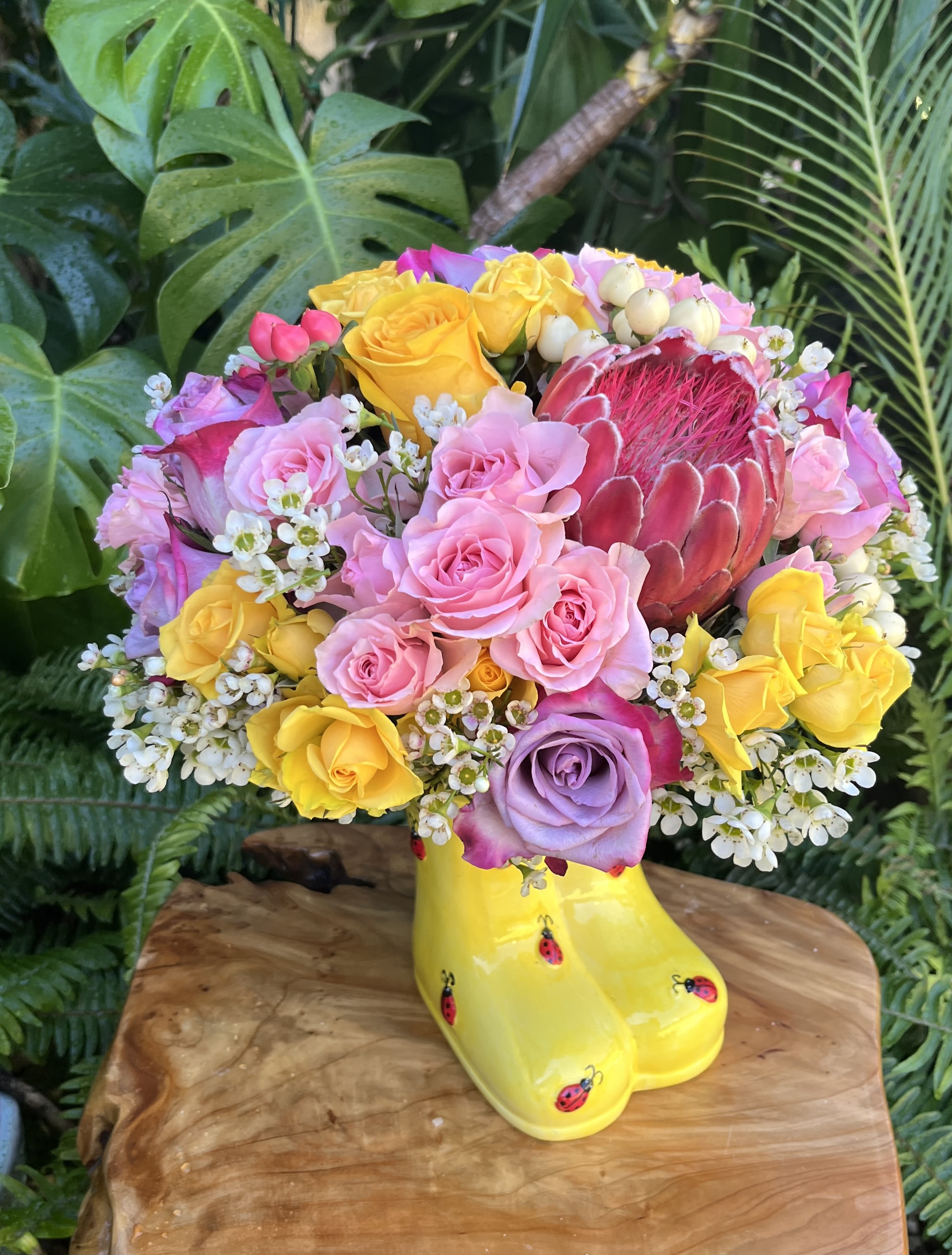 Ladybug boots  - Personally crafted, fresh, seasonal bouquet tastefully arranged in a 5 inch tall ceramic rain boots vase. The specific arrangement delivered will be determined by the designer. If you would like to request specific flower types and colors, please place your order in the Custom Arrangements section where you can specify those details or give us a call to discuss your ideas. 