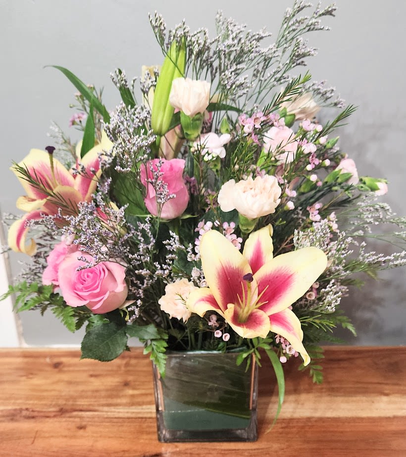 Pink Sandy - This is a Charming pink rose bouguet with lush greenery and rustic lilies. Perfect for that special someone!