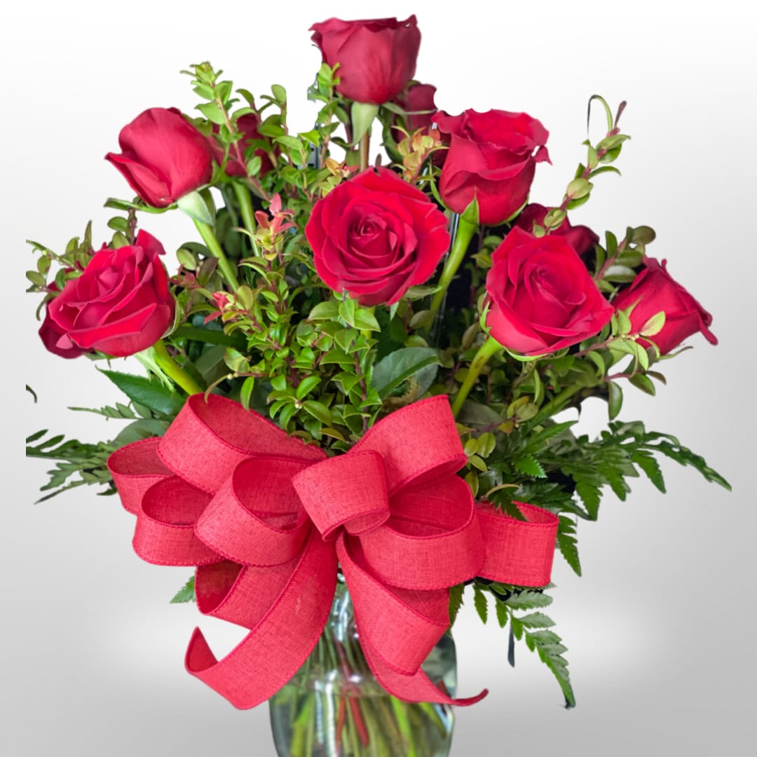 Classic Dozen Red Rose - A charming bouquet of a dozen fresh and fragrant  12 red roses, adorned with just a bit of greenery, is a classic Valentine’s Day gift. Delivered in a clear glass vase, this bouquet is also a romantic standard for any day of the year. 18 Roses for the Deluxe and 24 Roses in the premium. 