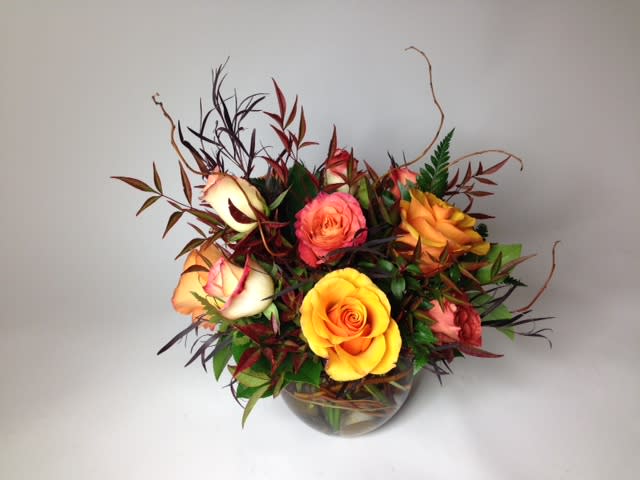 Apple Cider - a warm and moody piece for the unique romantic or a great father's day vibrant but masculine arrangement. 12 peach and orange toned roses in a low bubble bowl.