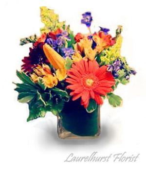 Colorful Cube Vase Arrangement - Seasonal bright flowers bound with a contemporary flair in this colorful cube arrangement.