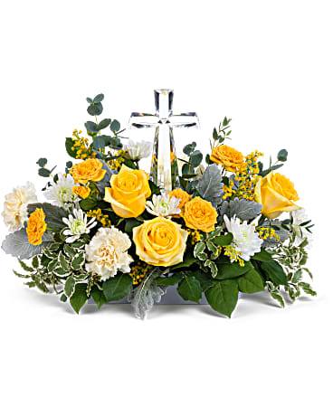 Be The Light Bouquet - Encircling a beautiful crystal cross keepsake, this sunny bouquet of roses and mums is a message of joy and hope. This hopeful arrangement includes yellow spray roses, light yellow carnations, white cushion spray chrysanthemums, yellow solidago, parvifolia eucalyptus, pitta negra, dusty miller and lemon leaf. Delivered with Teleflora's Small Crystal Cross.