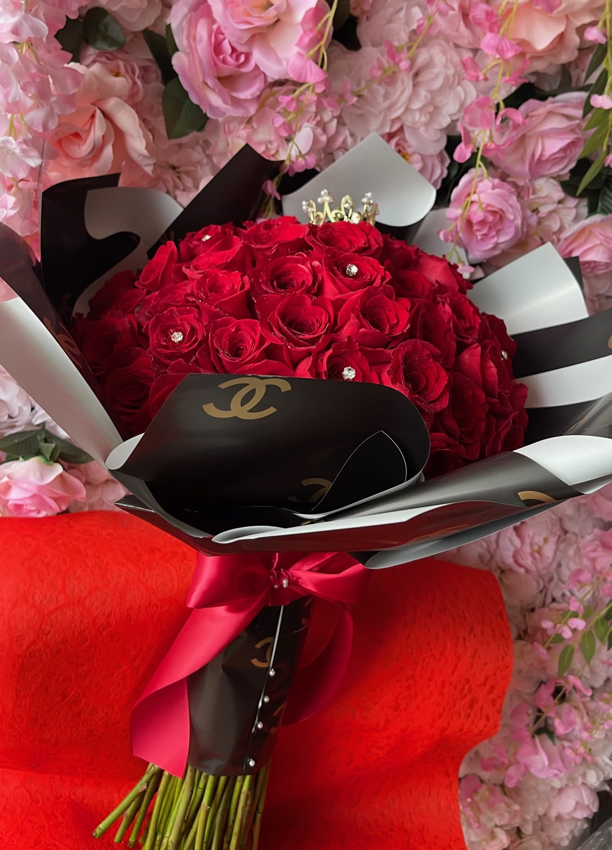 Coco Bouquet - Available in 3 Sizes. Pictured in Deluxe size Standard 4 dozen long stem red roses  Deluxe 6 dozen long stem red roses Premium 8 dozen (100)* Roses   Wrapped in exclusive double C paper. Available in other colors call to confirm.