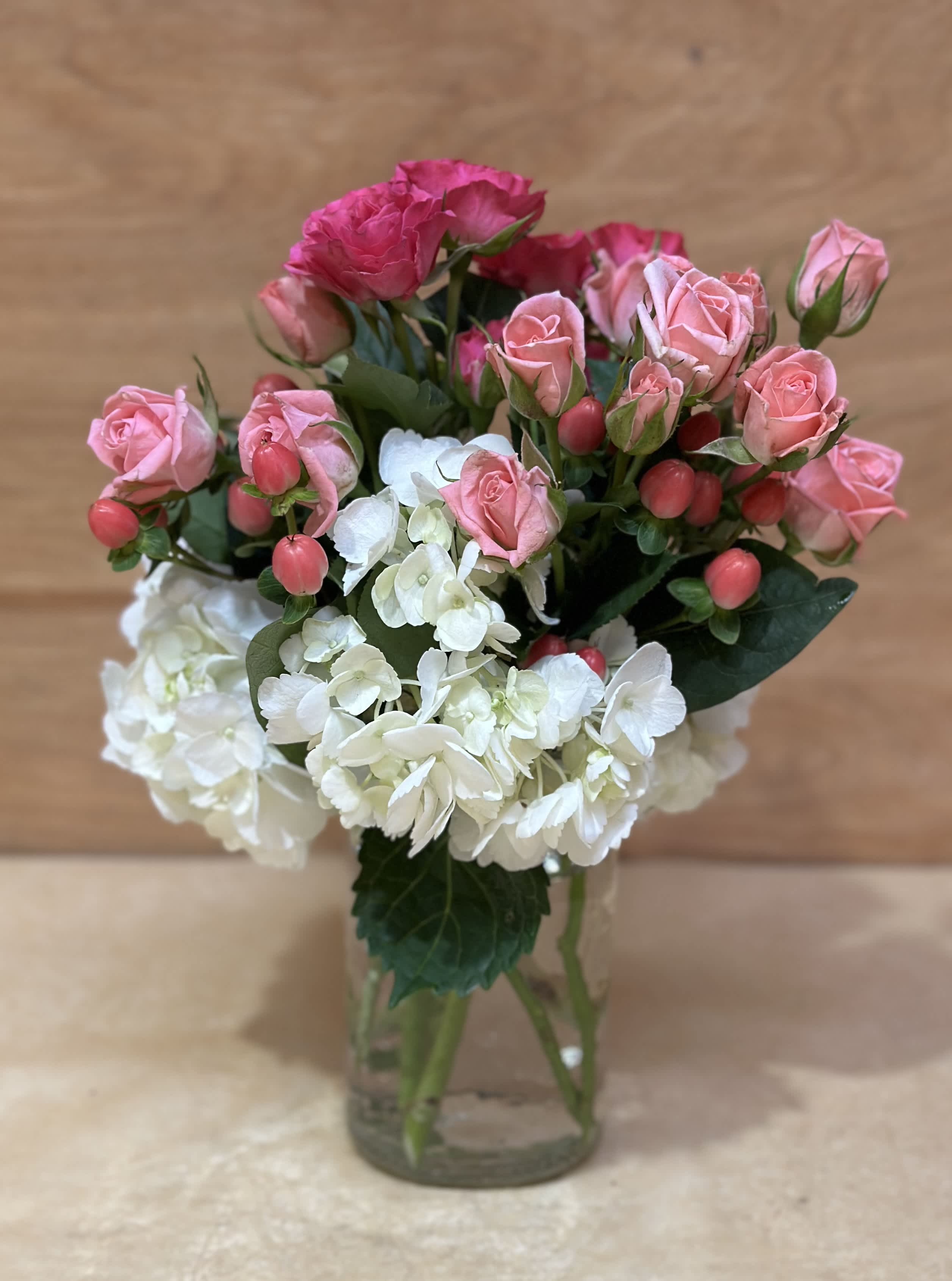 Sweet petite  - This sweet arrangement of soft pinks and whites is a precious gift to show your love.   White hydrangea, hypericum berries and spray roses gathered in a glass vase . Approx 9" h 