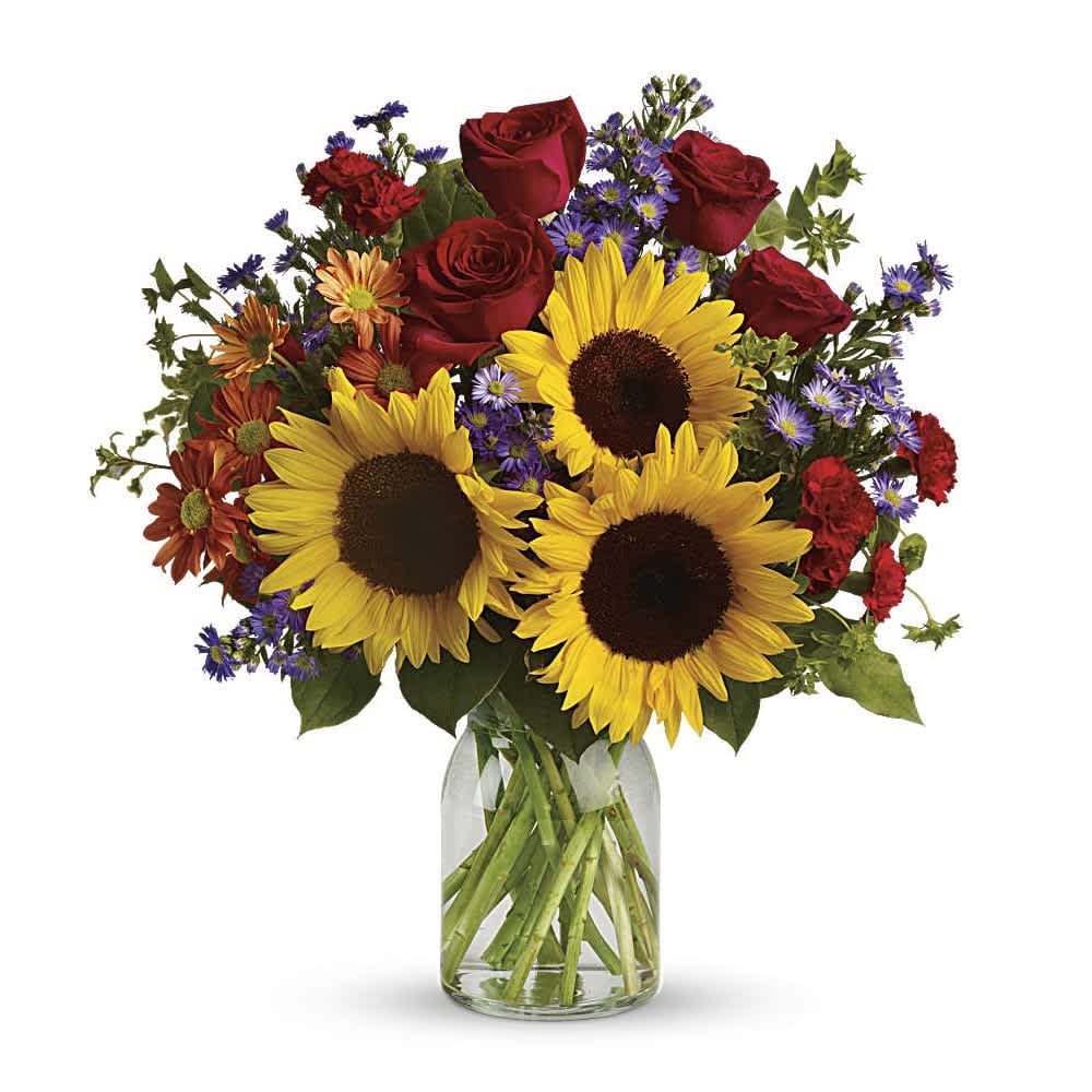 Pure Happiness - Pure happiness is what this pretty bouquet delivers - whether you're sending it for a fall birthday, Thanksgiving, thank you, or simply just because. Surely, no one can be in the presence of something so inherently happy and not smile. Sunny sunflowers, red roses and miniature carnations, bronze daisy spray chrysanthemums, large lavender monte cassino asters and autumn greens are beautifully arranged in a clear glass vase.