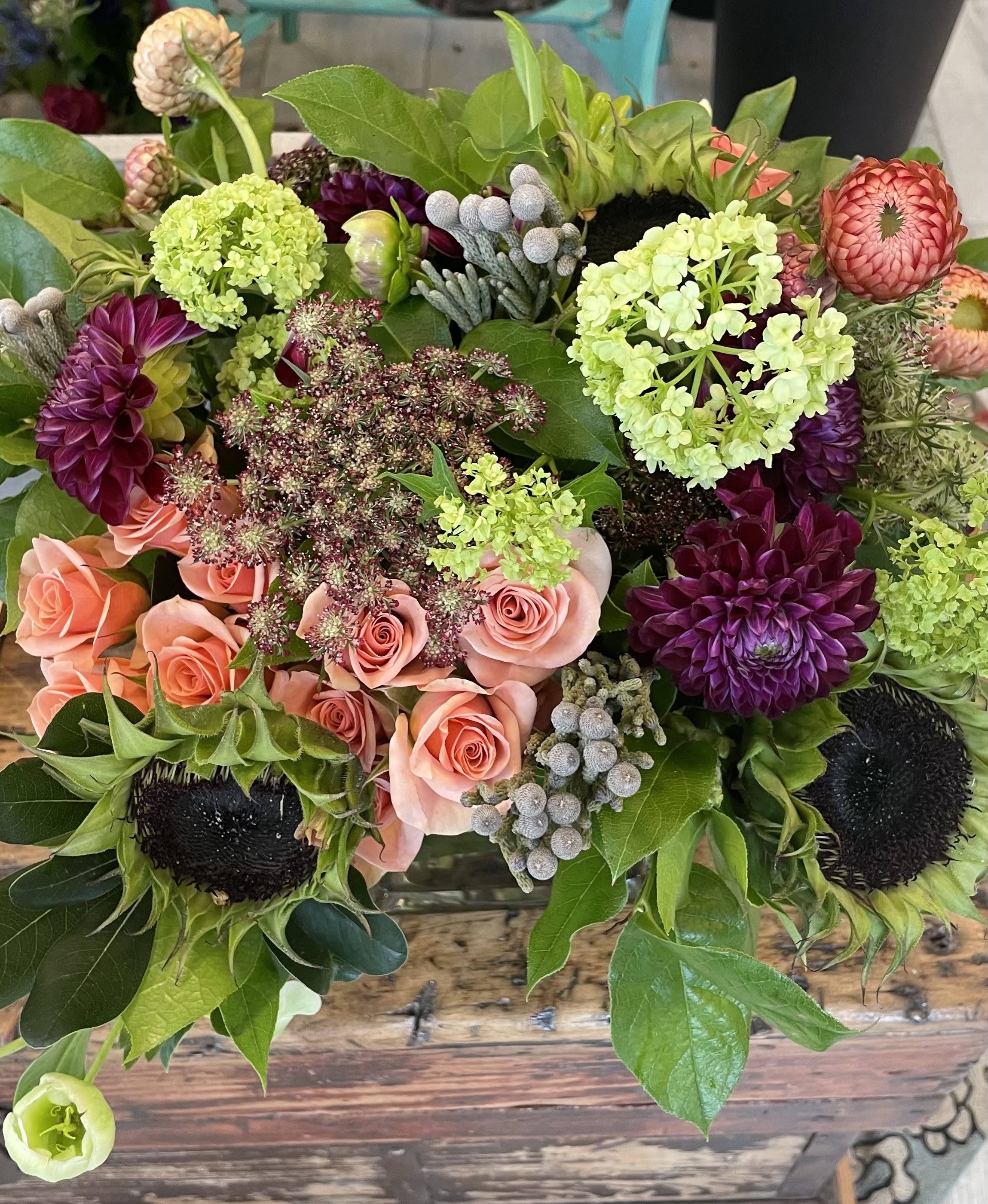 Let the Sun in - Sun flowers, spray roses, brunia,  dahlia, straw flower, hellebores in a vase.