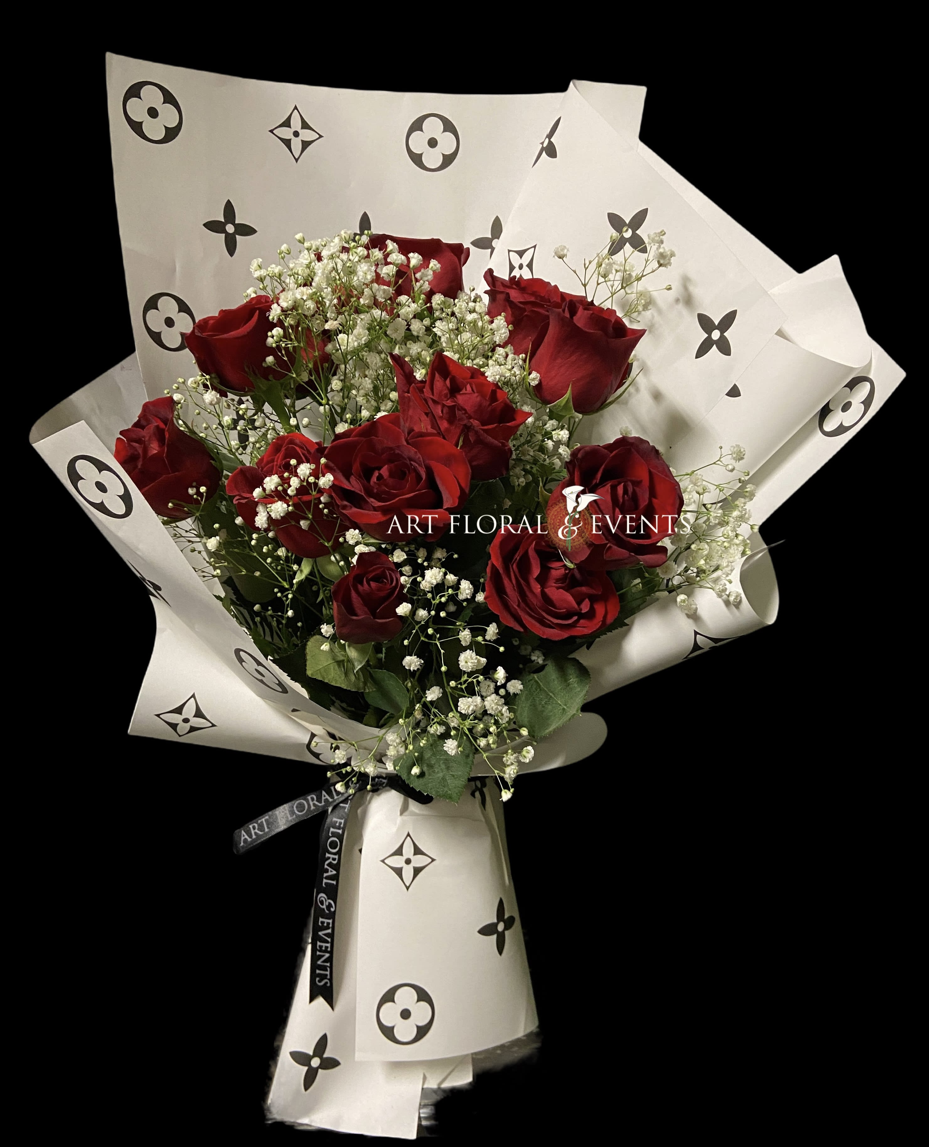 Love in Luxury - Hand wrapped bouquet made with 12 Red Roses surrounding foliage and luxury white paper wrapping. VASE INCLUDED