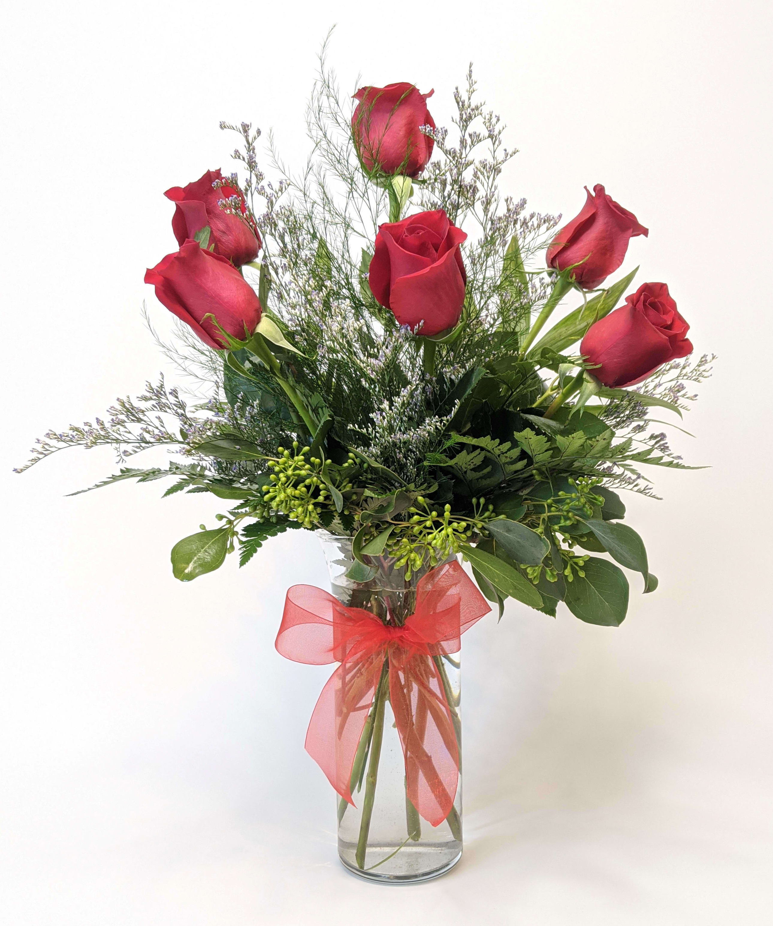Half Dozen Red Roses - A charming half dozen red roses, with stunning filler and unique foliage's. 
