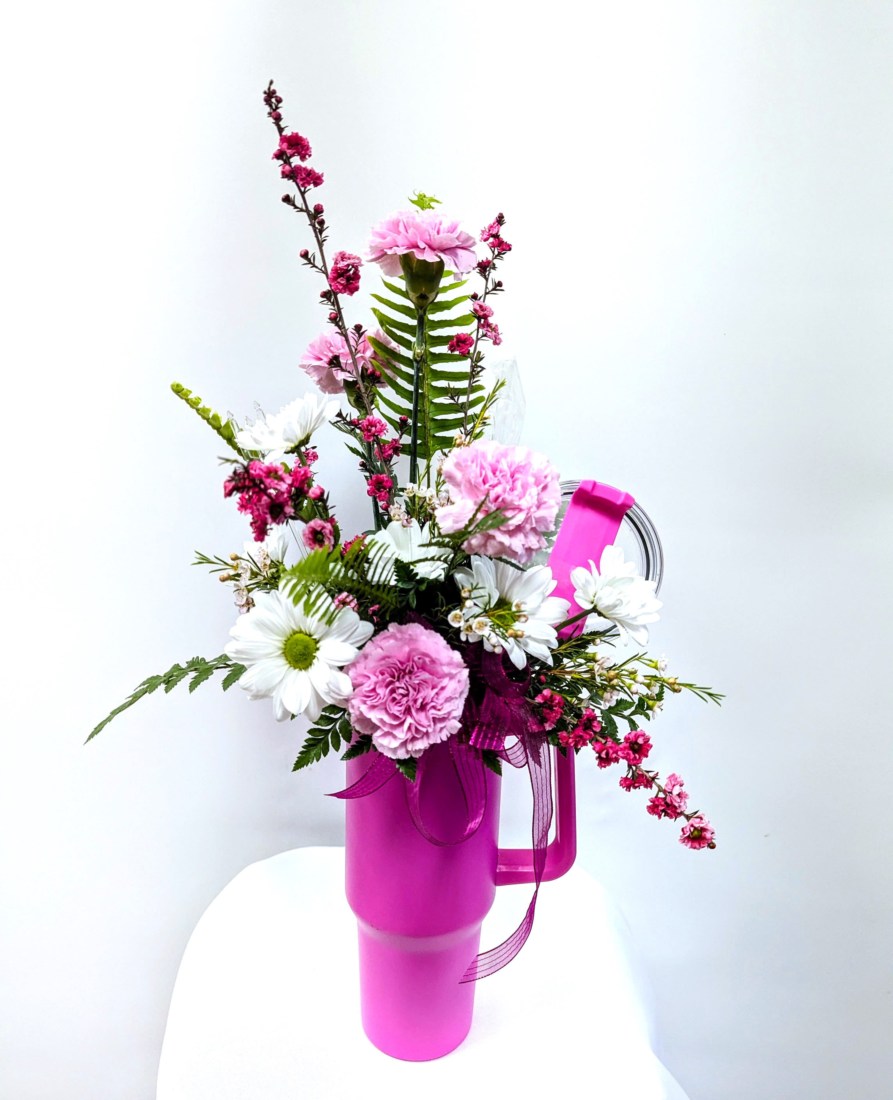Gift Tumbler With Seasonal Blooms - A beautiful display of seasonal flowers, displayed in a novelty tumbler cup. Gift your loved one the best of both worlds! Beautiful flowers and a stainless steel tumbler with a straw.  !!!Colors on Tumbler may vary!!! Please call the shop directly to specify tumbler color.