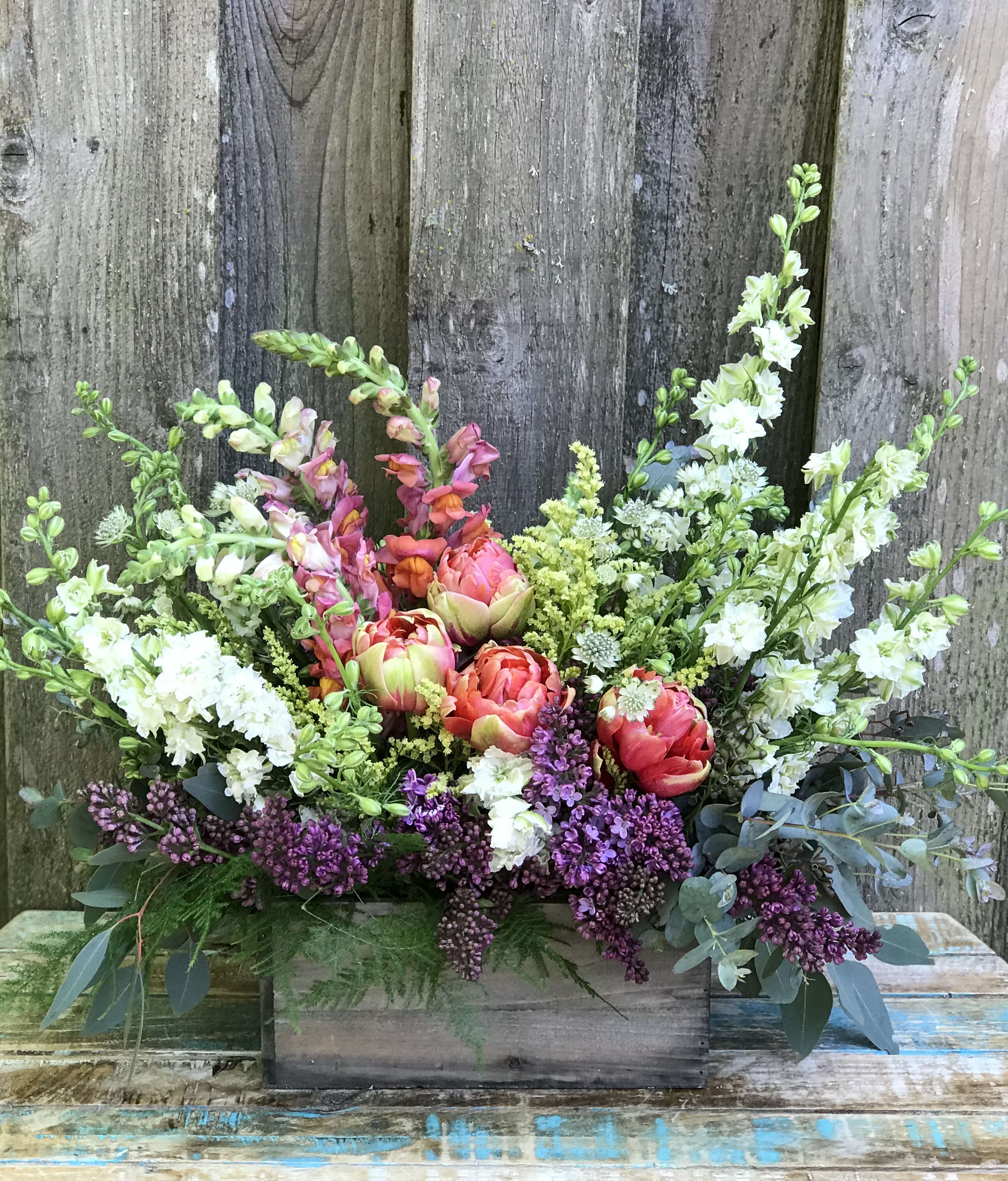 Flower Box - A mix of the freshest seasonal flowers in cheerful colors gathered in a flower box. Colors and blooms vary with seasonal availability.