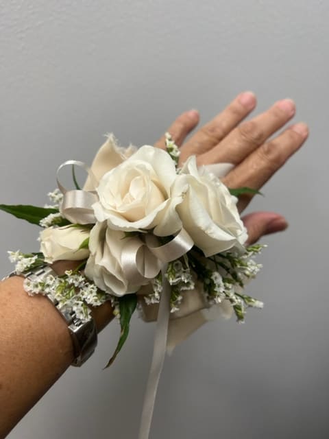 Corsage - Pin or Wrist Corsage.  Photo is just a sample.  Actual flowers uses will vary based on availability.  Please call shop for details. 