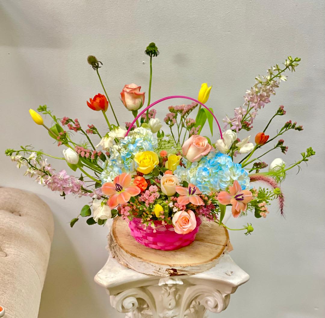 Wild &amp; Whimsical  - Theme Colors: Shades of peach and yellow in a basket   Featured Blooms: Roses, hydrangeas, tulips, larkspur, statice and green mist with Seasonal Blooms  HK Flowers have a uniqueness of florals and seasonal blooms, certain flowers or colors may not be available as each season affects the availability, color, size, and shape of each floral bloom. Some flowers may be substituted accordingly.  Photos are used as a reference for the color palette and is NOT indicated of the final product. We ask for your trust in us that we will pick out the best seasonal available blooms, while still capturing the arrangements' theme and colors mentioned above.