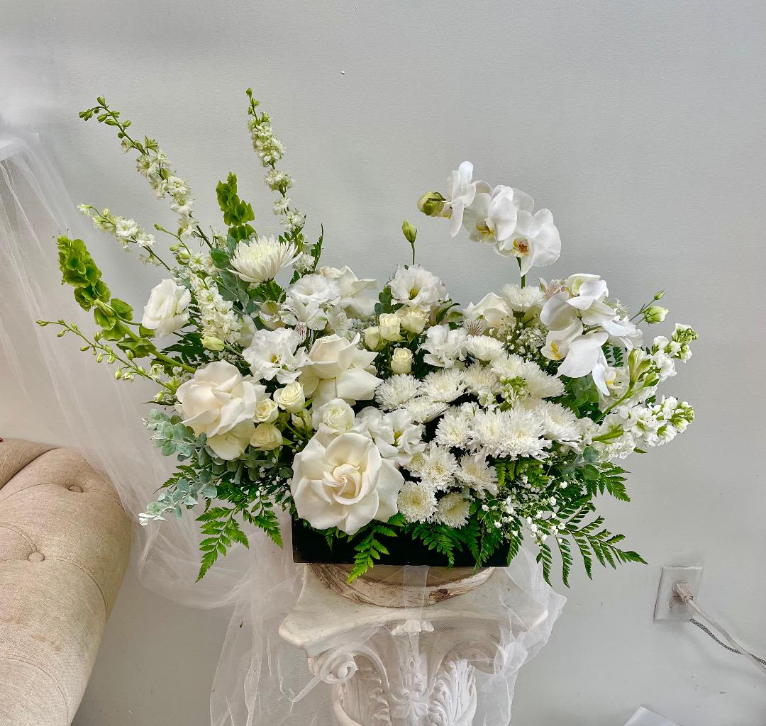 White Emperor - Product Information Theme Colors: whites  Featured Blooms: Roses, Spray Roses, orchid, Stock, Larkspur, Lisianthus, Bells of Ireland, Alstroemeria, Seasonal Blooms  HK Flowers have a uniqueness of florals and seasonal blooms, certain flowers or colors may not be available as each season affects the availability, color, size, and shape of each floral bloom. Some flowers may be substituted accordingly.  Photos are used as a reference for the color palette and is NOT indicated of the final product. We ask for your trust in us that we will pick out the best seasonal available blooms, while still capturing the arrangements' theme and colors mentioned above.