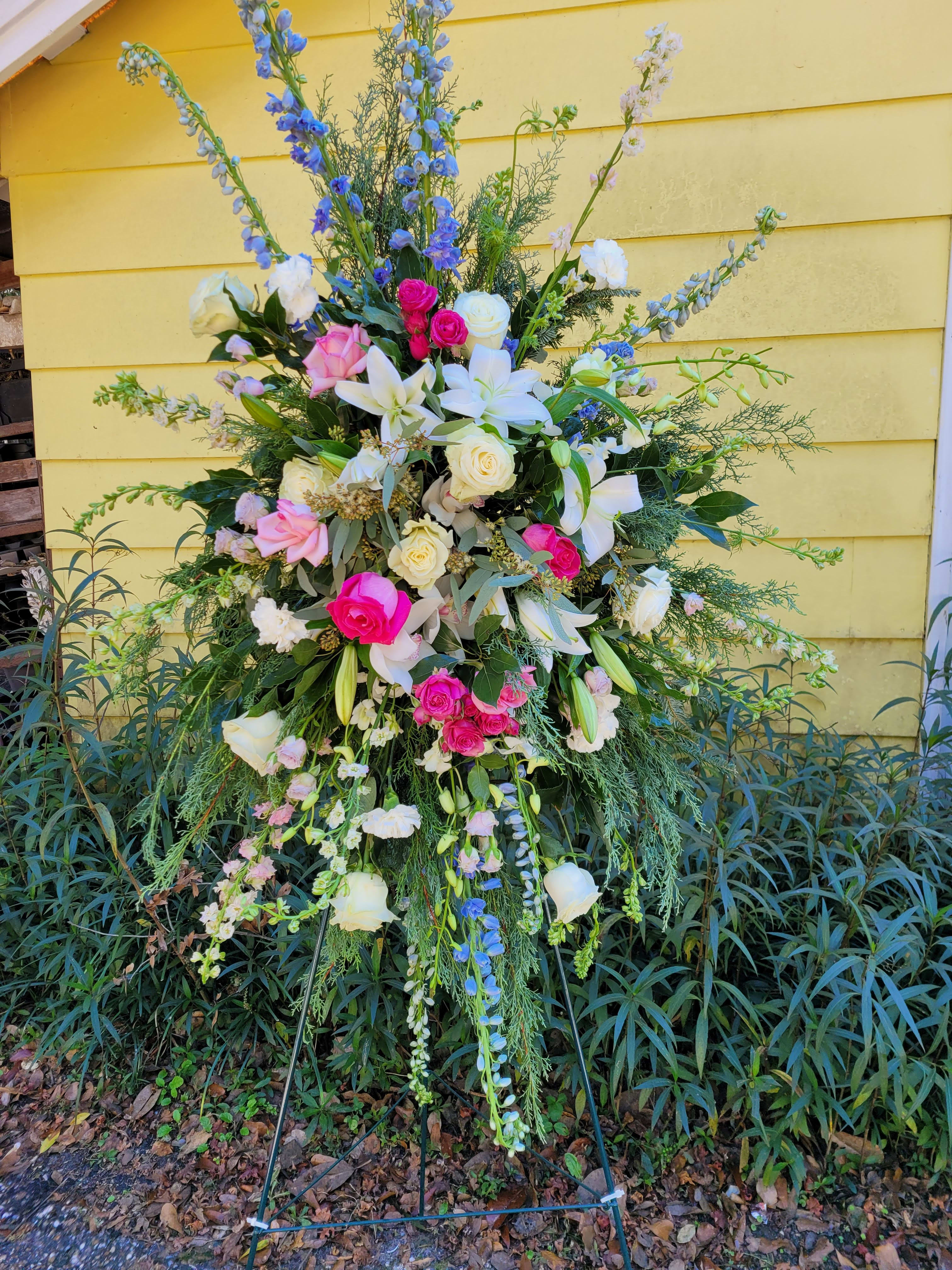 Sympathy - Fairwell Wishes - A Gentle Expression of Comfort and Remembrance The "Sympathy Fairwell Wishes" is a beautiful arrangement designed to offer solace and honor the memory of a loved one. This tribute features a harmonious blend of seasonal flowers such as delphinium, lilies, stock, garden roses, and hydrangea, complemented by delicate blooms and natural foliage like eucalyptus. **Garden Tones: The arrangement showcases a soothing palette of pastel blues, pinks, rose tones, and whites, creating a serene and comforting display. **Elegant Florals: Each flower is carefully selected for its beauty and symbolism, providing a fitting tribute that conveys your heartfelt condolences. **Natural Accents: Eucalyptus and other natural foliage add texture and depth, enhancing the overall elegance of the arrangement. Choose the "Sympathy Fairwell Wishes" from Elizabeth's Garden to express your compassion and support during times of mourning, offering a gentle reminder of love and remembrance.