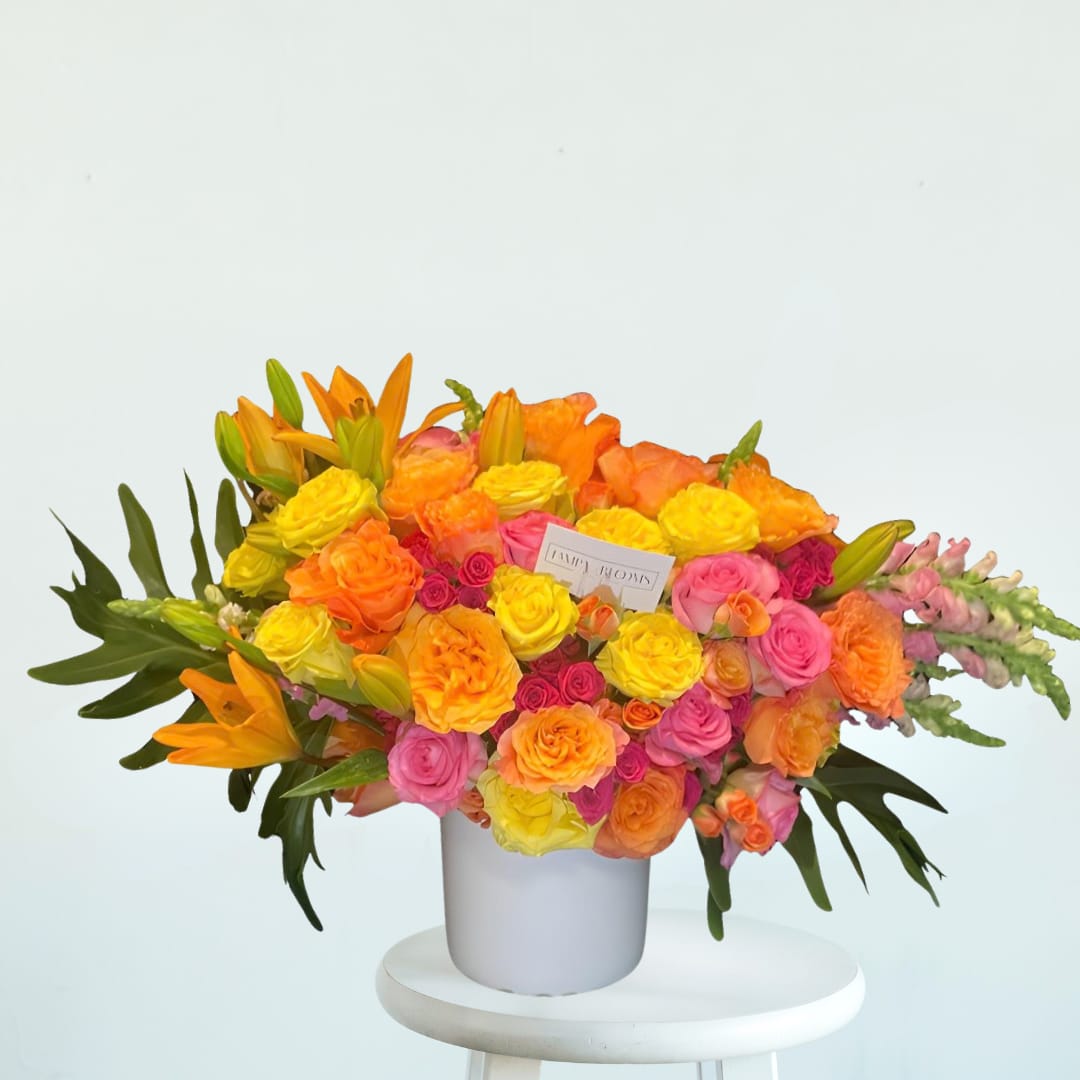 Passionfruit - Vibrant, expressive, and bursting with color, Passionfruit is a large, show-stopping floral arrangement designed to turn heads. This lush design features an energetic mix of assorted roses and spray roses in multiple colors, accented with elegant snapdragons and dramatic large monstera leaves for a modern tropical touch.  Rich in texture and movement, Passionfruit blends romance with bold, contemporary flair — perfect for celebrations, milestones, or anyone who loves color and personality in their florals.  Design Details:  Assortment of roses and spray roses in mixed vibrant colors  Accented with snapdragons and lilies for height and movement  Finished with large monstera leaves for a bold, modern look  Designed as a large, full statement arrangement  Ideal for birthdays, congratulations, celebrations, or when you want something unforgettable and full of life.